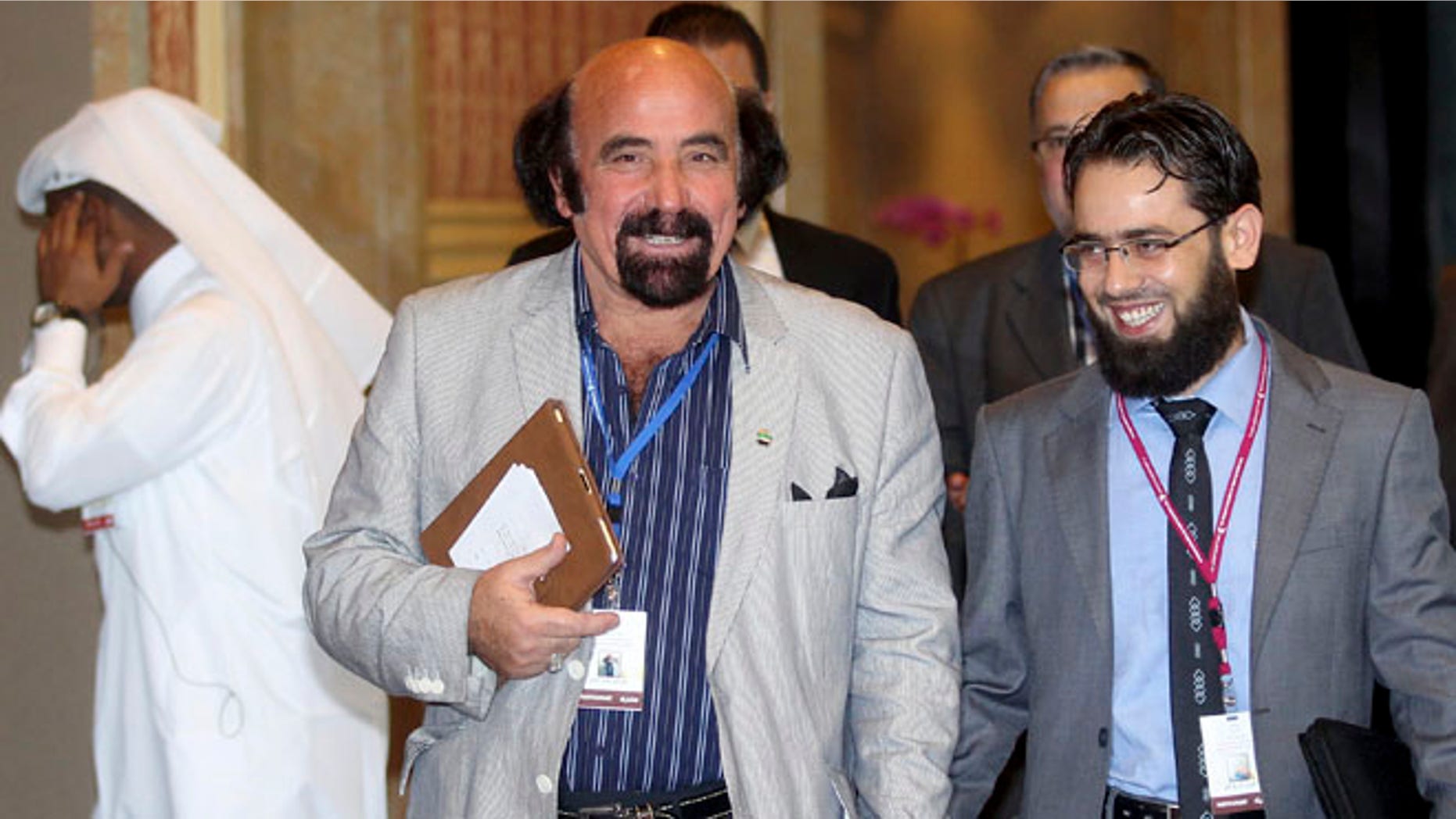 Nov. 6, 2012: Syrian regime opponents Mohiuddin Abdullah Alathighani, left, and Ghazwan Sheikh Ali attend the meeting of the General Assembly of the Syrian National Council in Doha, Qatar.