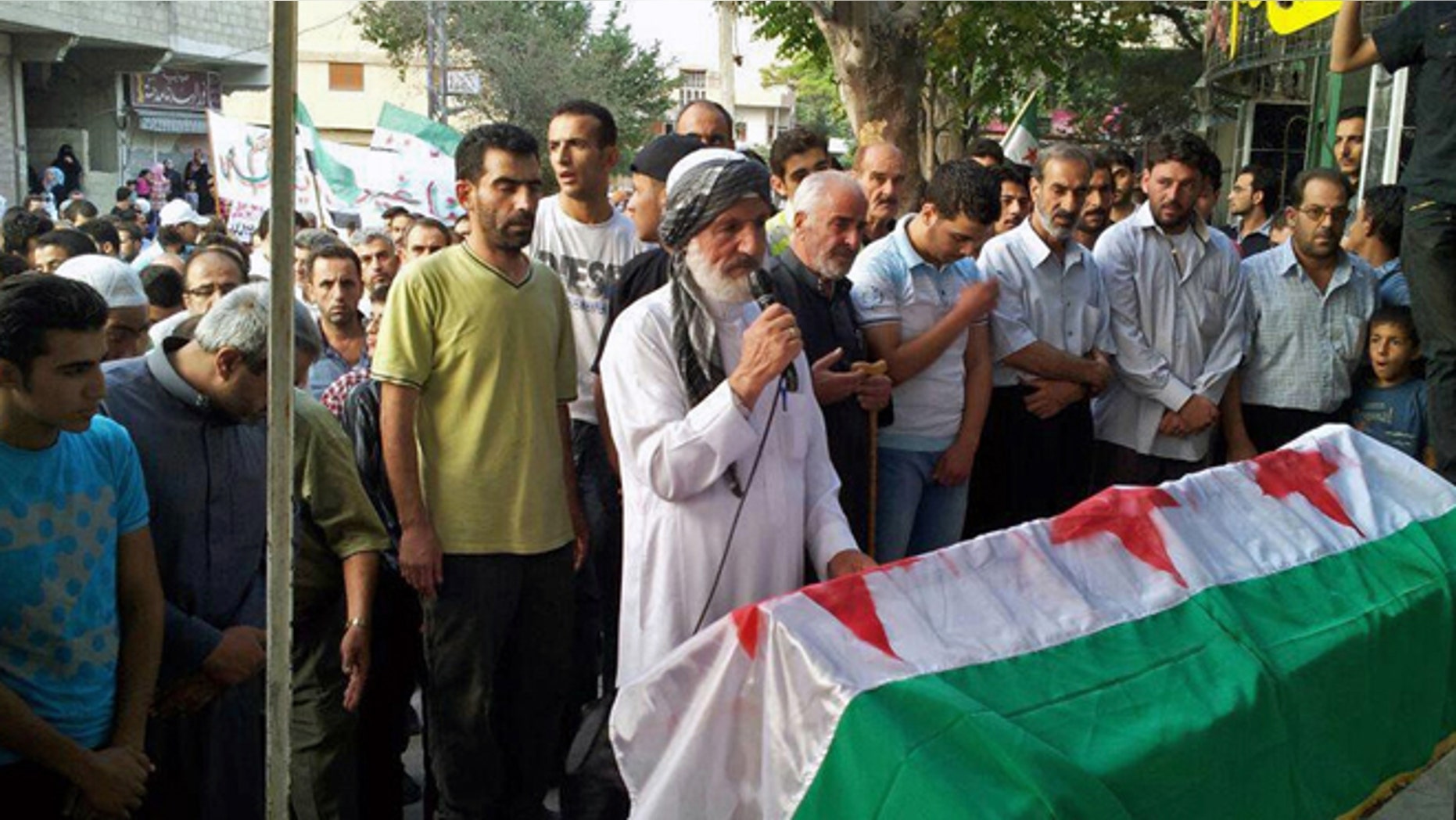 This citizen journalism image provided by Shaam News Network SNN, taken on Friday, Aug. 31, 2012, purports to show the funeral of Ahmed Ismail Zaqzuq, killed in fighting with pro-government forces in Damascus, Syria.