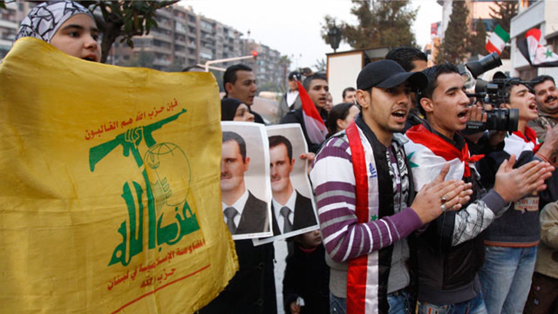 Nov. 24, 2011: Pro-Syrian regime protesters hold Hezbollah flags and shout pro-Syrian President Bashar Assad slogans during a protest in front the Iranian embassy to thank Iran for their support of the Syrian regime, in Damascus, Syria.