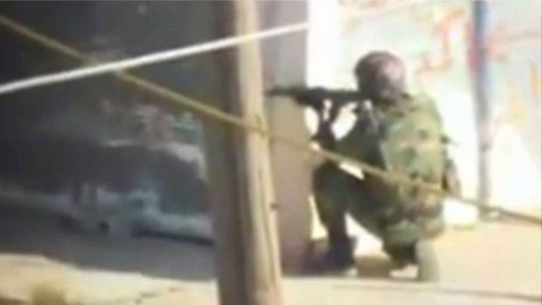 Dec. 2, 2011: Amateur video shows a soldier taking aim in Homs, Syria.