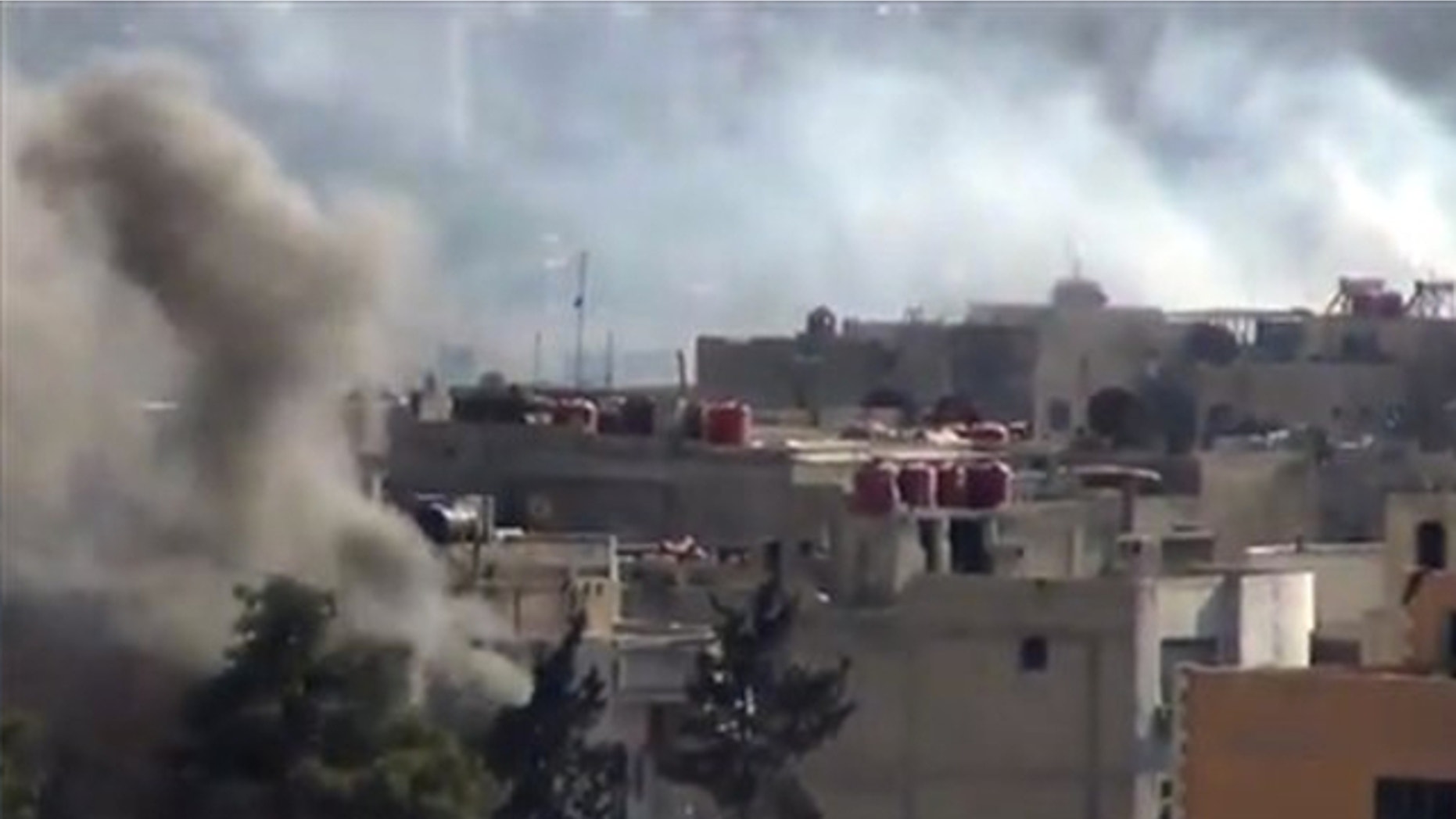 Sept. 4, 2013: Smoke rises from buildings due to heavy clashes between Free Syrian army fighters and government forces in Daraya, a suburb of Damascus, Syria.