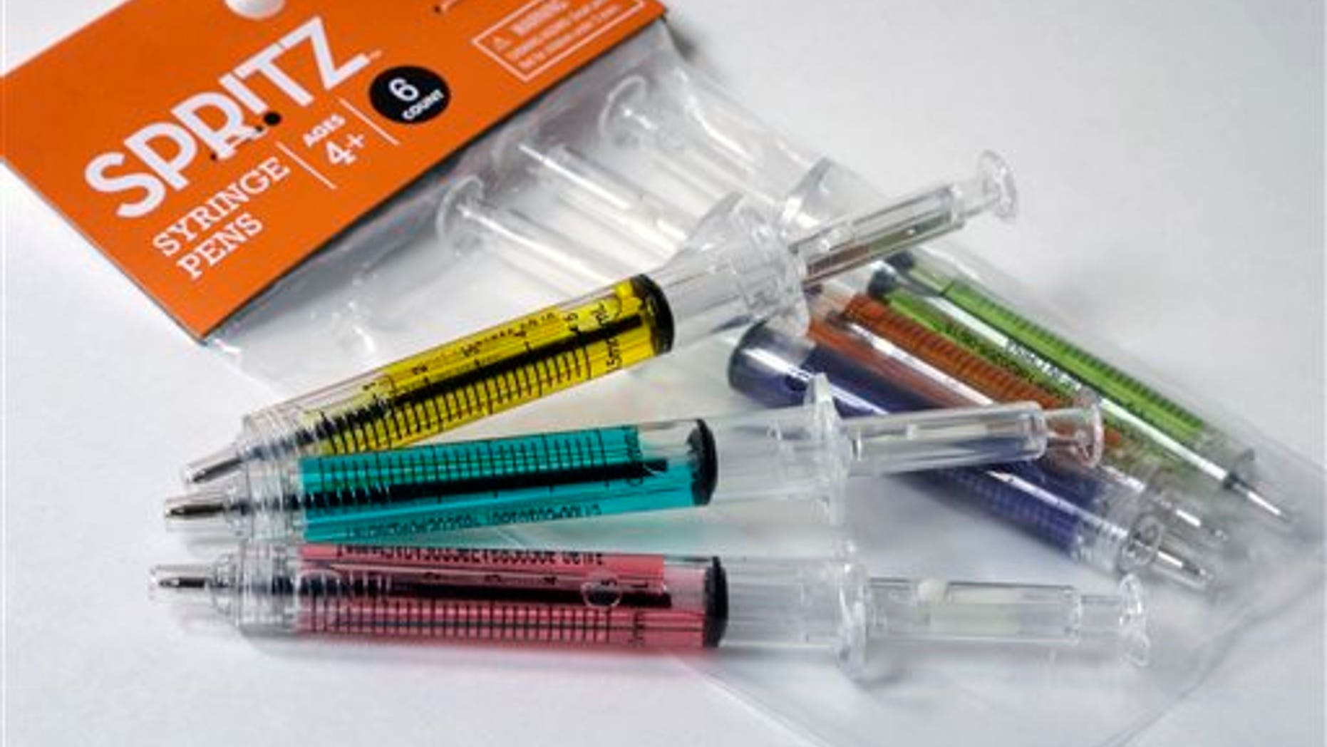 In this Wednesday, Oct. 14, 2015, photo, pens that look like syringes are displayed with their packaging in Boston. The pens are being sold as Halloween novelty toys at Target stores and some online retailers. (AP Photo/Steven Senne)