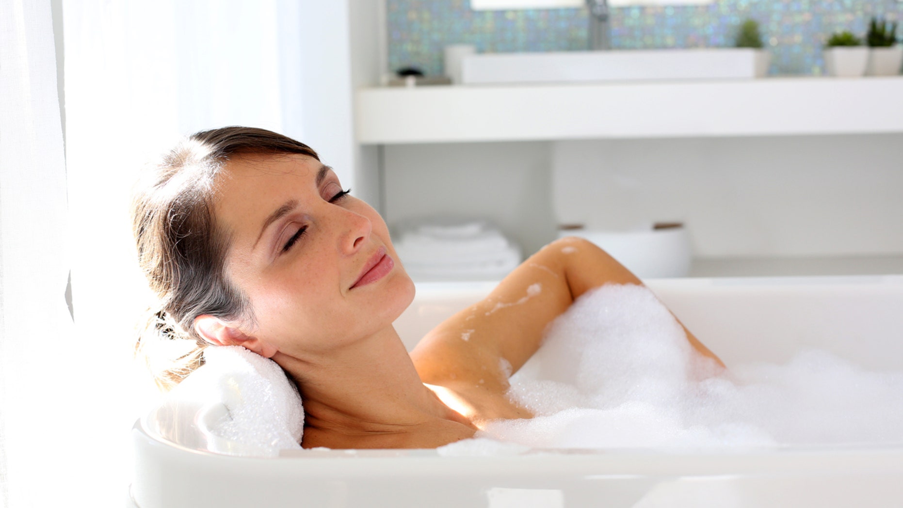 Beautiful woman relaxing in bathtub