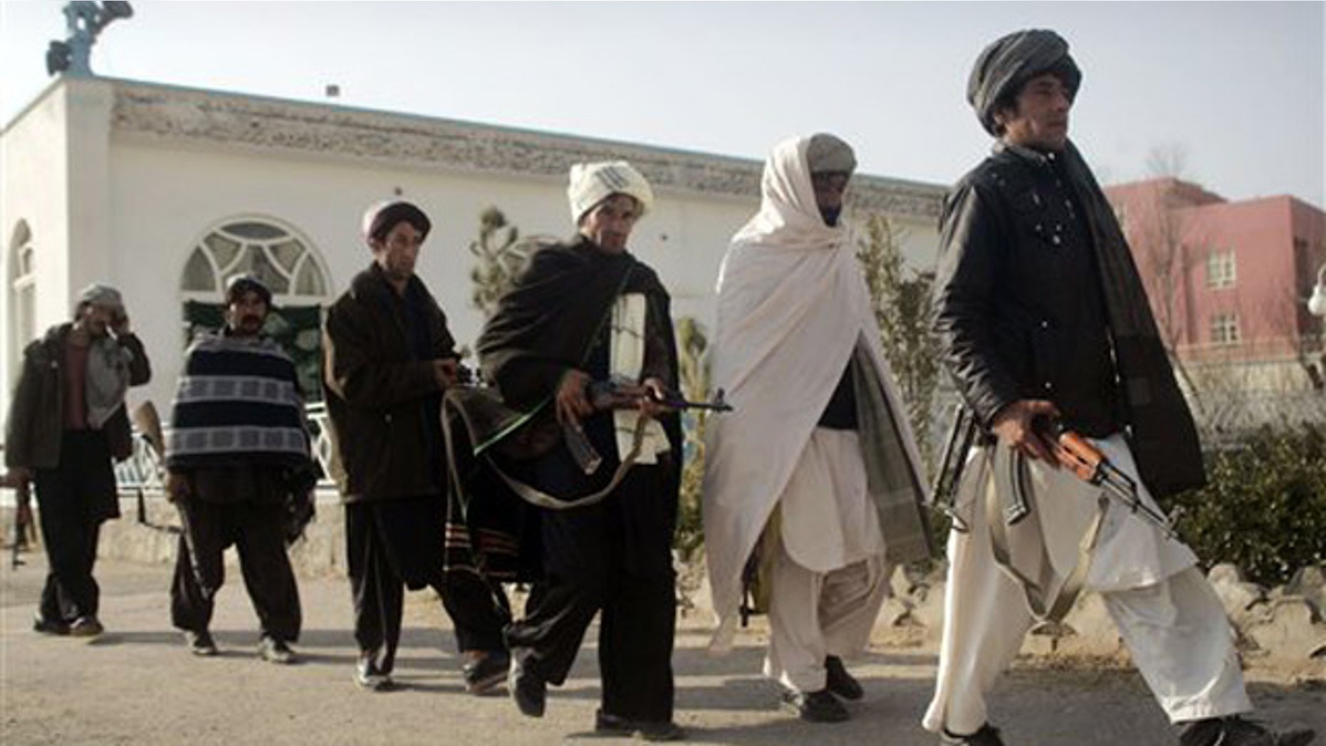 Dec. 28, 2011: Former Taliban militants walk to hand over their weapons during a joining ceremony with the Afghan government in Herat, Afghanistan.
