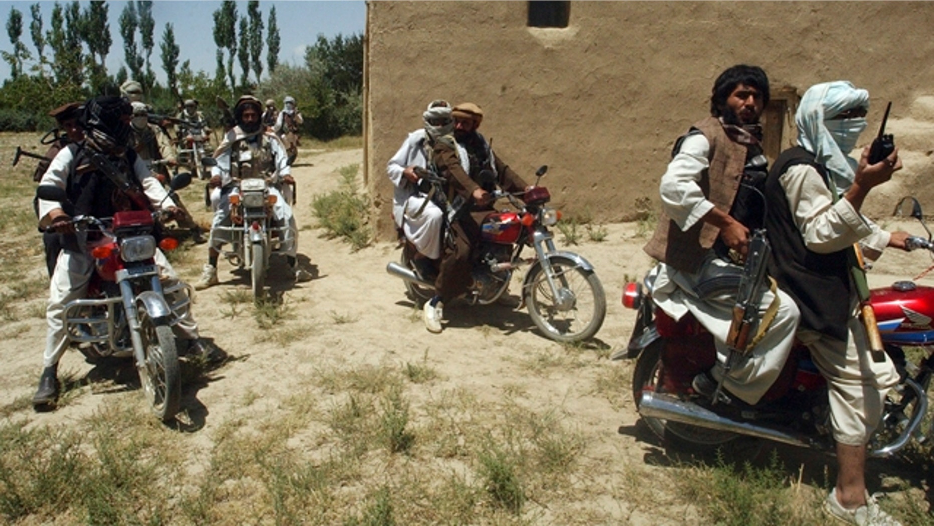 Taliban fighters ride on motorbikes in an undisclosed location in Afghanistan, July 14, 2009. (Reuters)