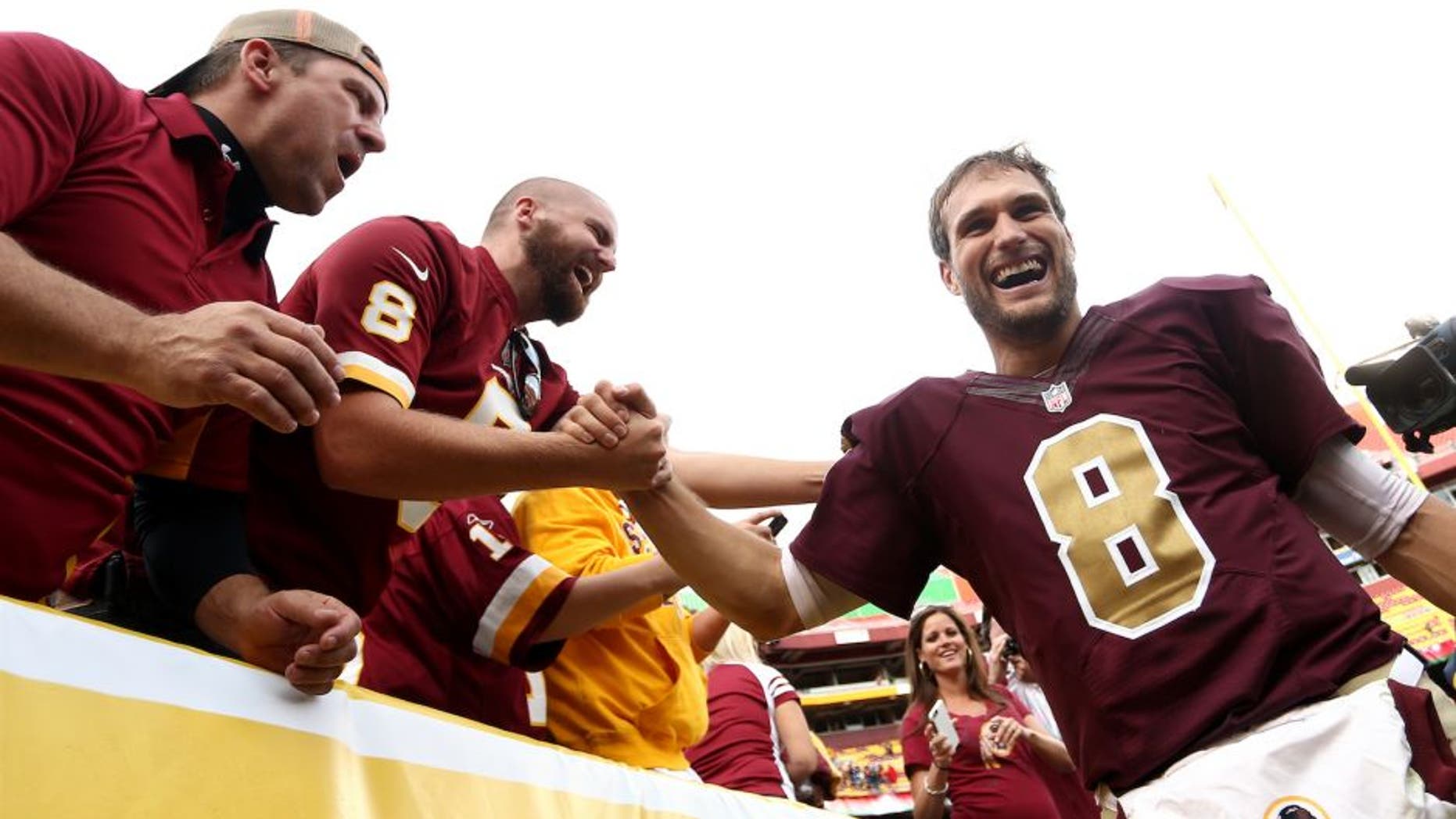 LANDOVER, MD - OCTOBER 25: Quarterback Kirk Cousins #8 of the Washington Redskins celebrates with fans after defeating the Tampa Bay Buccaneers 31-30 during a game at FedExField on October 25, 2015 in Landover, Maryland. (Photo by Matt Hazlett/Getty Images)