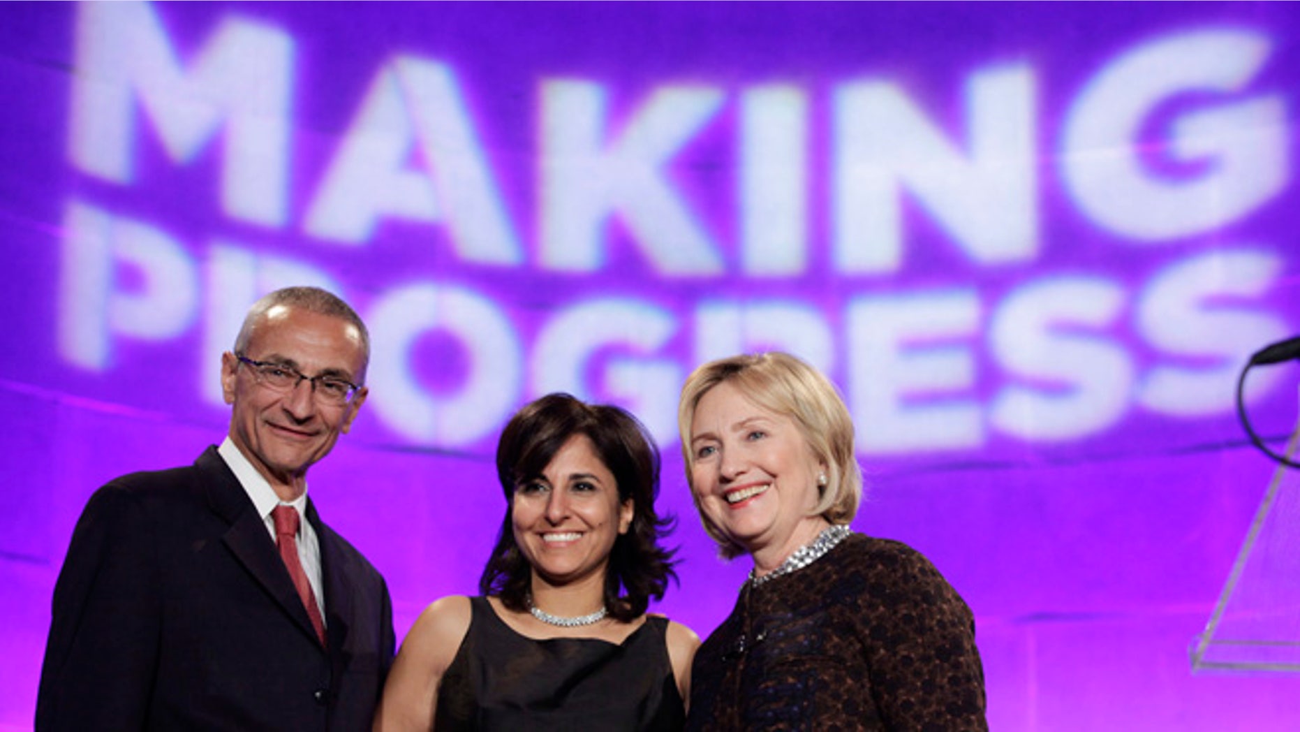 FILE: October 24, 2013: Hillary Clinton (r) with President of the Center for American Progress Neera Tanden and CAP founder John Podesta, Washington, D.C. REUTERS
