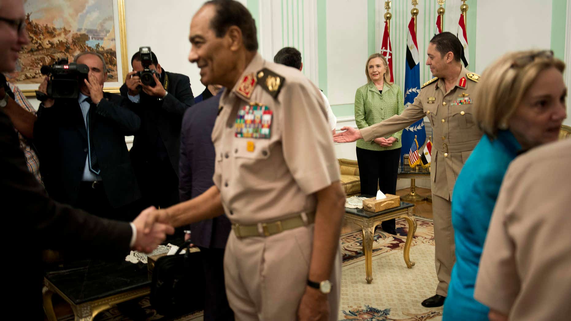 July 15, 2012: US Secretary of State Hillary Rodham Clinton, back center, watches as Field Marshal Hussein Tantawi, second left, greets members of the American delegation before a meeting at the Ministry of Defense in Cairo, Egypt.