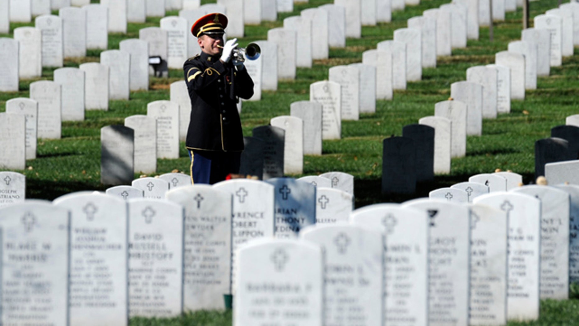 A bugler plays 'Taps' during the 2009 funeral for Army Spc. Stephen Mace at Arlington Cemetery in Arlington, Va. Due to a looming budget cut on Oct. 1, virtually all military funerals in New York state will use an electronic bugle instead of a live performance. (AP)