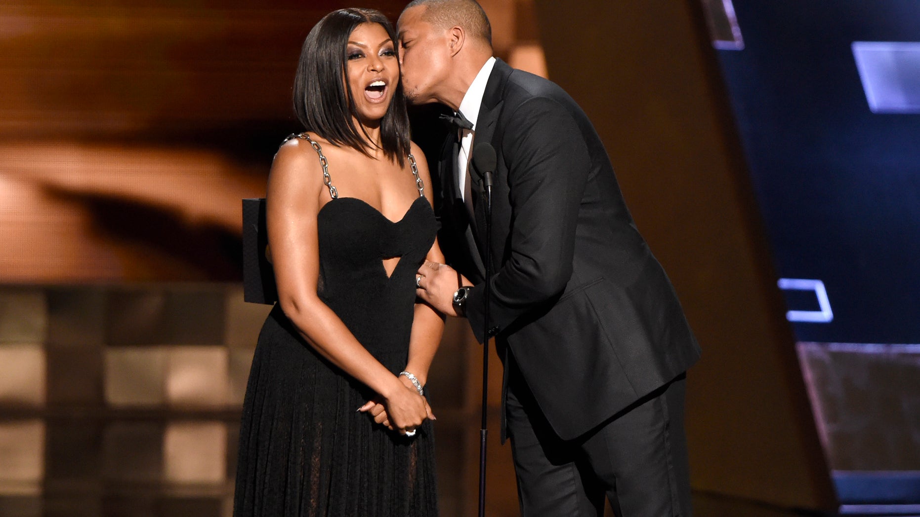 Taraji P. Henson, left, receives a kiss from Terrence Howard as they present the award for outstanding supporting actress in a limited series or a movie at the 67th Primetime Emmy Awards on Sunday, Sept. 20, 2015, at the Microsoft Theater in Los Angeles. (Photo by Chris Pizzello/Invision/AP)