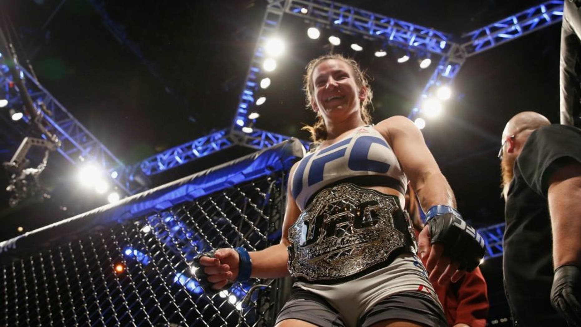 in their UFC women's bantamweight championship bout during the UFC 196 event inside MGM Grand Garden Arena on March 5, 2016 in Las Vegas, Nevada.