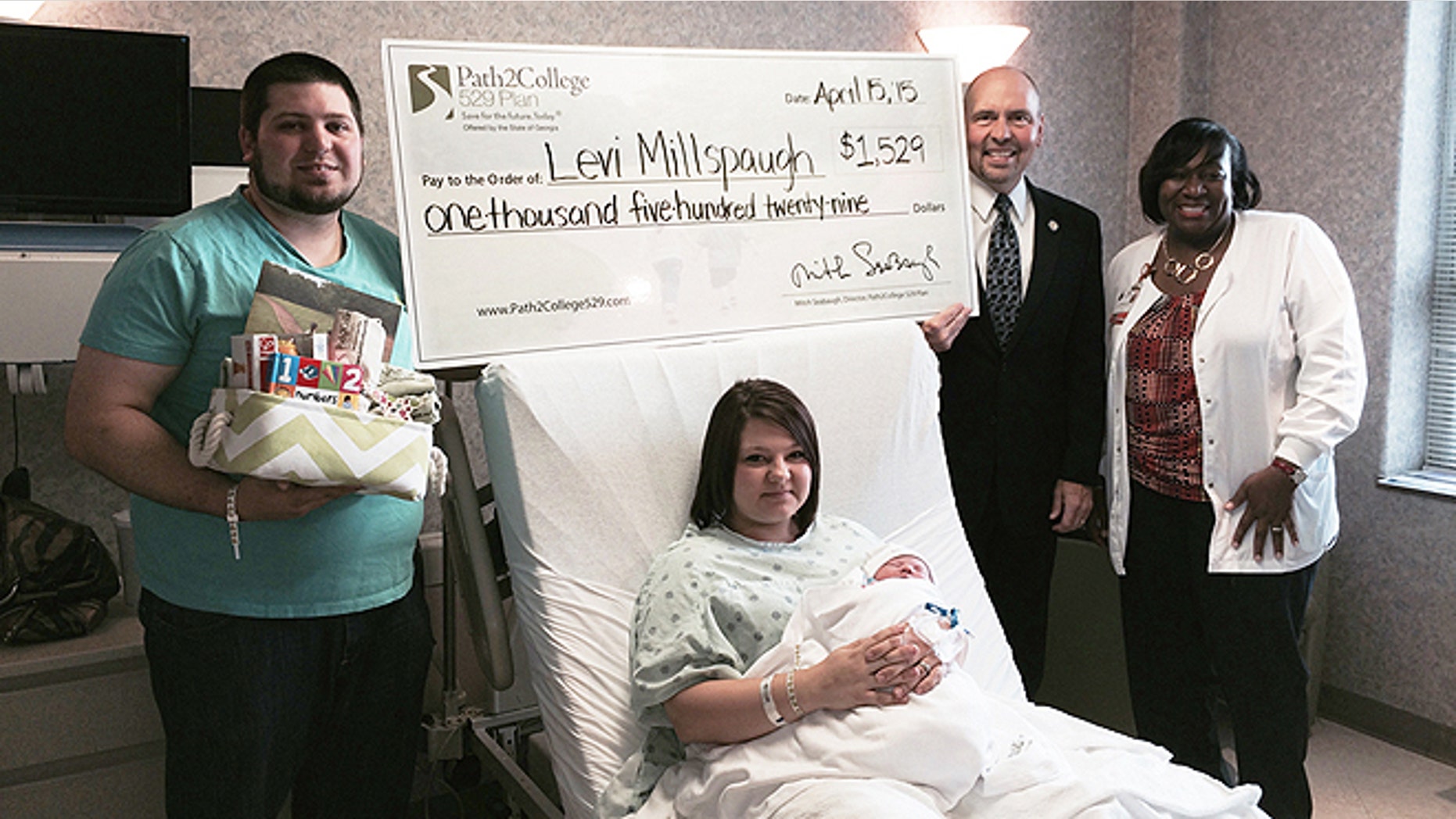 Levi Millspaugh, seen here with mother Kayla (center) and father Aaron (left), received a kick start to his college savings after being the first born on tax day at a Savannah, Ga., hospital. (Memorial Hospital)