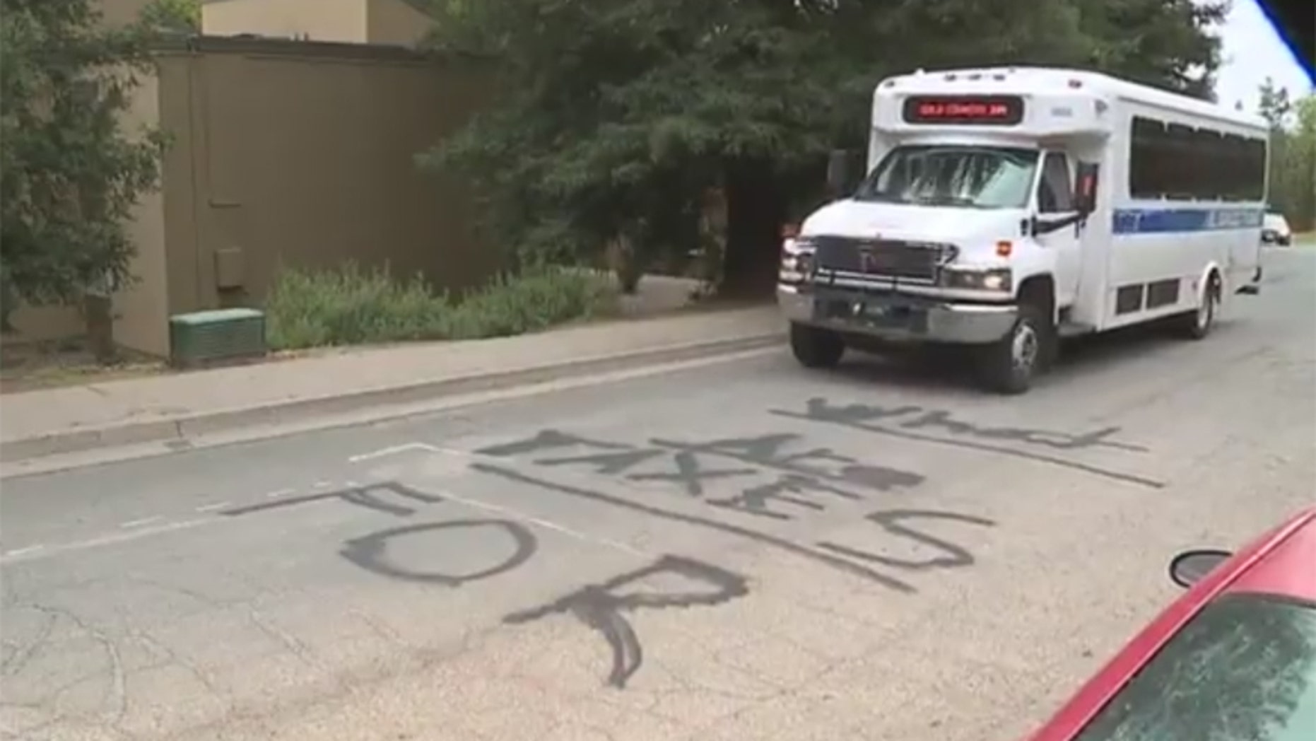 A message that says "What are taxes for?" is written on the pavement of a street in Placerville, Calif.