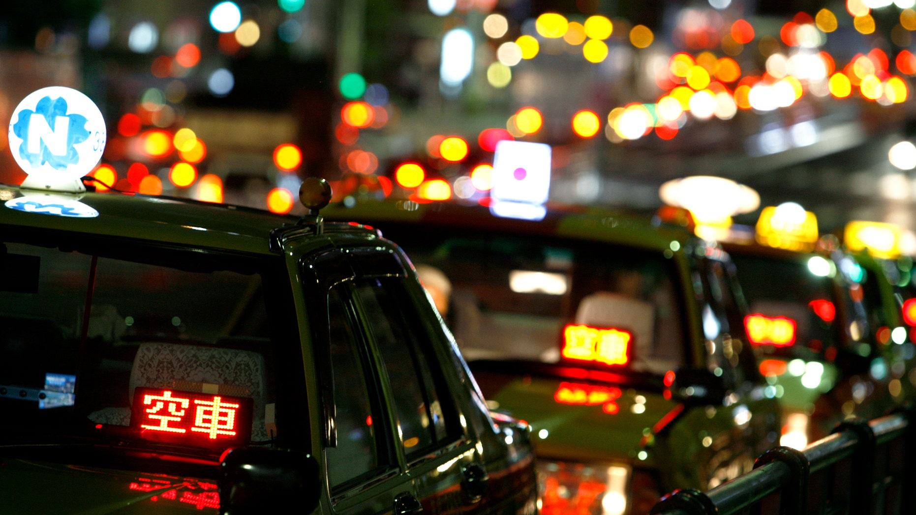 File photo - Taxis are parked as drivers wait for customers on a road in Tokyo Aug. 3, 2009. (REUTERS/Stringer)