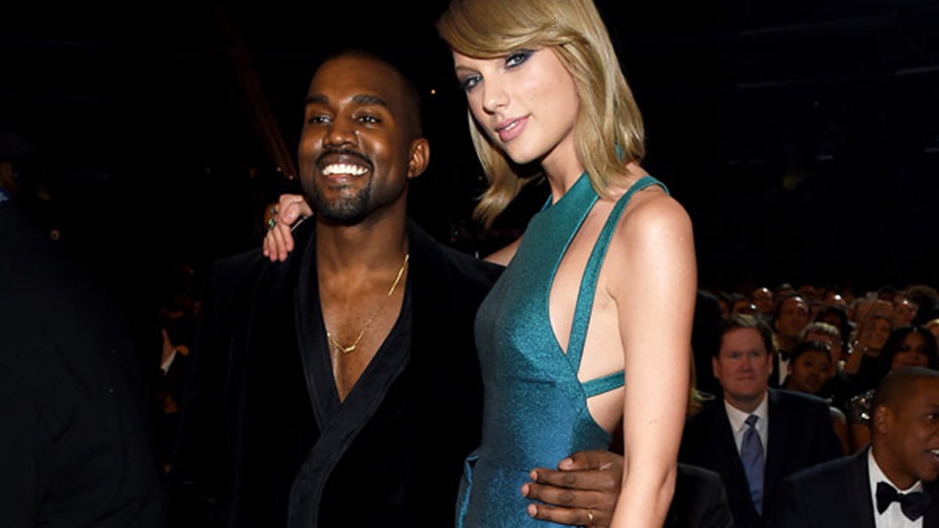 Kanye West and Taylor Swift pose for a photo together at the 2015 Grammy Awards.