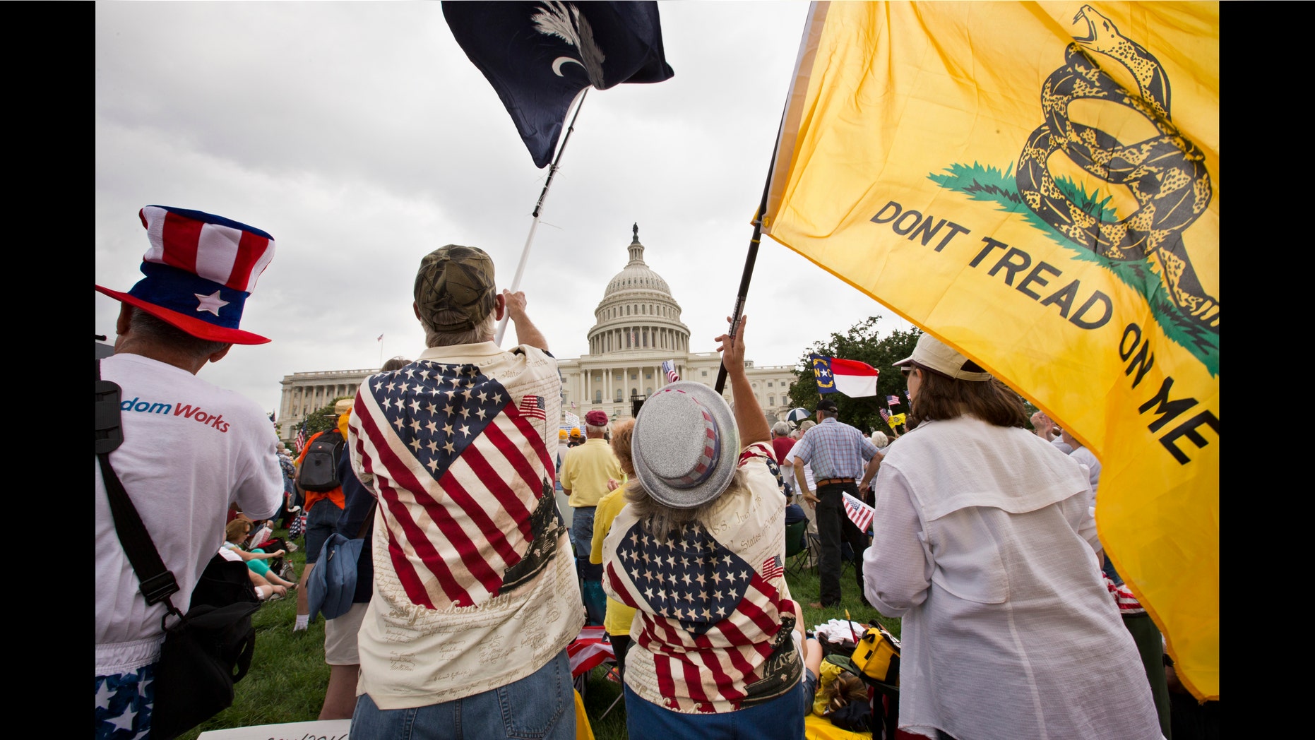 In this June 19, 2013, photo, Tea Party activists attend a rally on the grounds of the Capitol in Washington, Wednesday, June 19, 2013. Six months after Hispanics overwhelmingly helped return President Barack Obama to office and control of the Senate to Democrats, House Speaker John Boehner is the face of the GOP effort to bite into that base of support _ or at least stop alienating a demographic that accounts for 17 percent of the nation. That means getting a new policy on immigration, perhaps the most delicate political dance of Boehnerâs career. (AP Photo/J. Scott Applewhite)