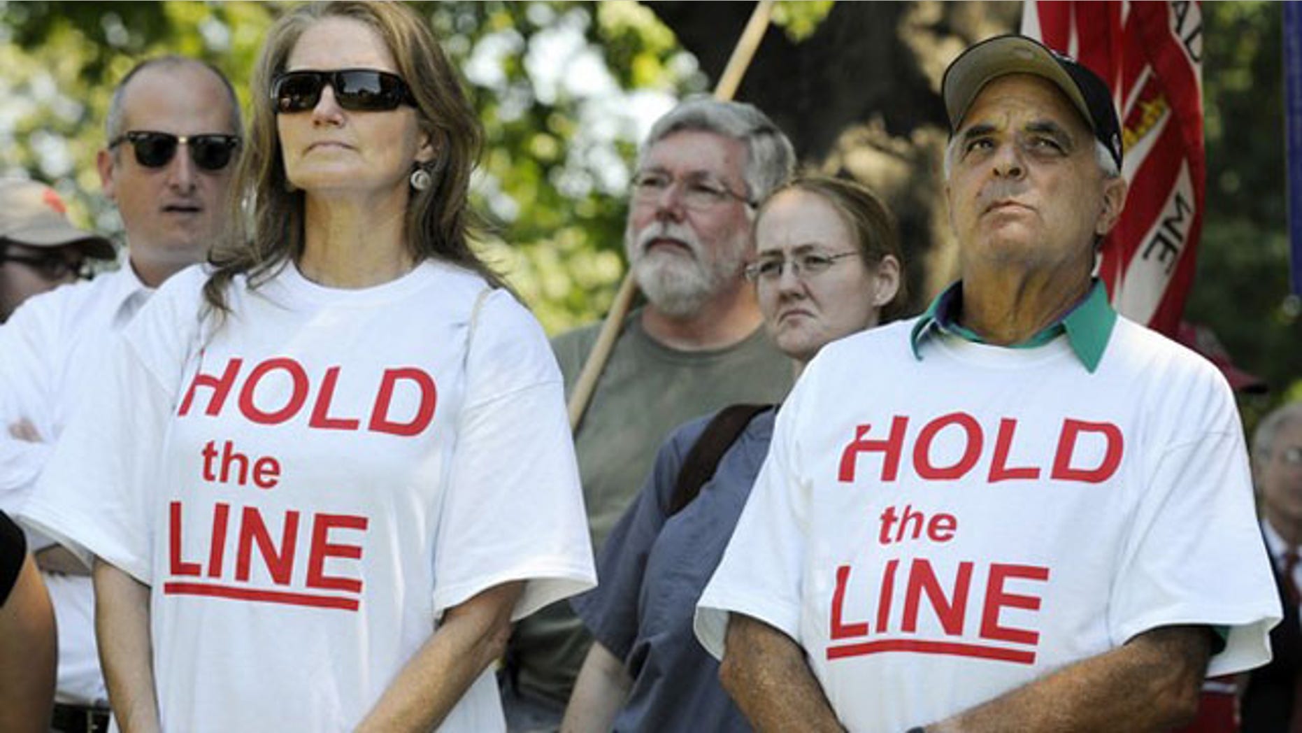 FIle: Tea Party supporters wear 'Hold the Line' t-shirts as dozens rallied near the U.S. Capitol against raising the debt limit in Washington July 27.