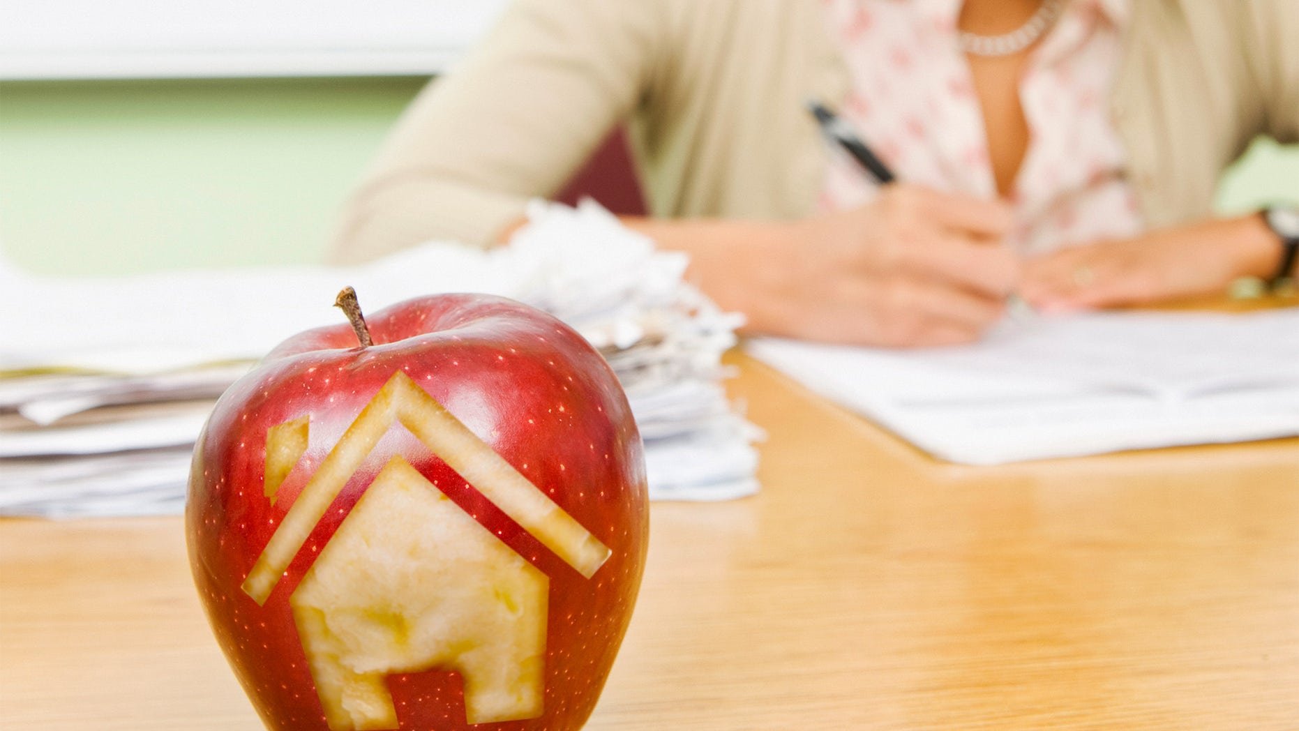house carved into teacher's apple