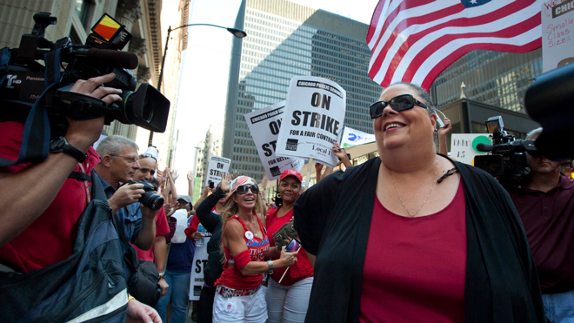 Chicago Teachers Union President Karen Lewis takes a break from negotiations with the Chicago Board of Education to make an unexpected appearance at a rally of thousands of public school teachers on Tuesday, Sept. 11, 2012 in Chicago. Teachers walked off the job Monday for the first time in 25 years over issues that include pay raises, classroom conditions, job security and teacher evaluations. (AP Photo/Sitthixay Ditthavong)