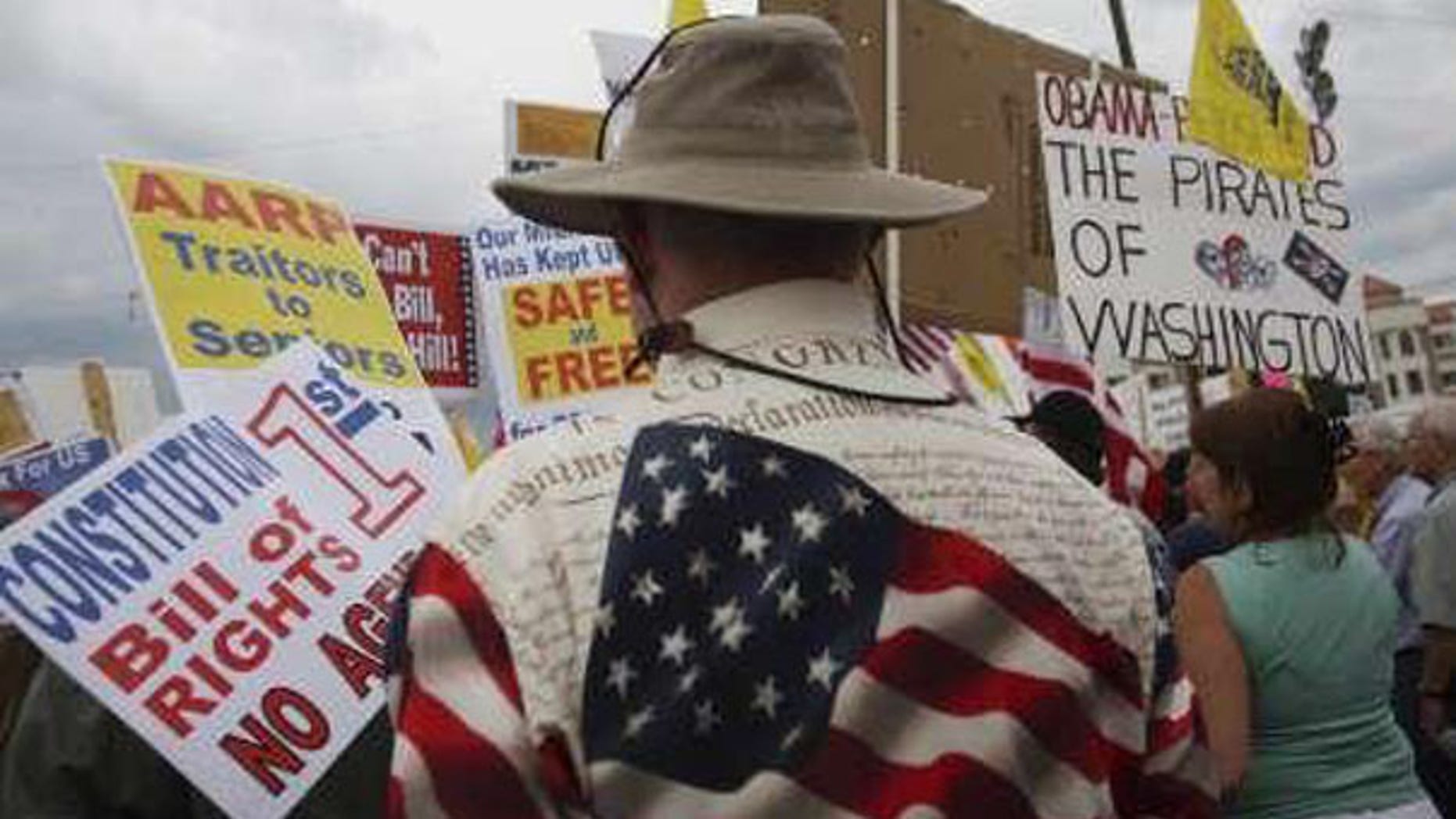 In this Aug. 31 file photo, "tea party" demonstrators hold signs at a protest in Flagstaff, Ariz. (Reuters Photo)