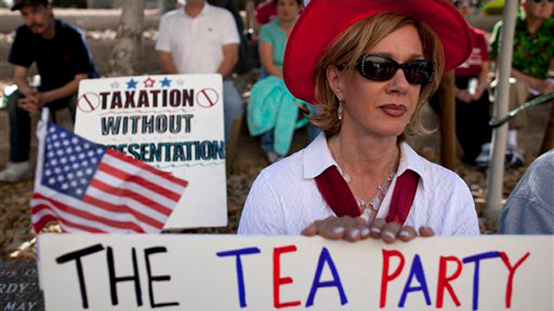 In this April 15 file photo, an activist in Las Vegas listens to speakers during a Tea Party rally.