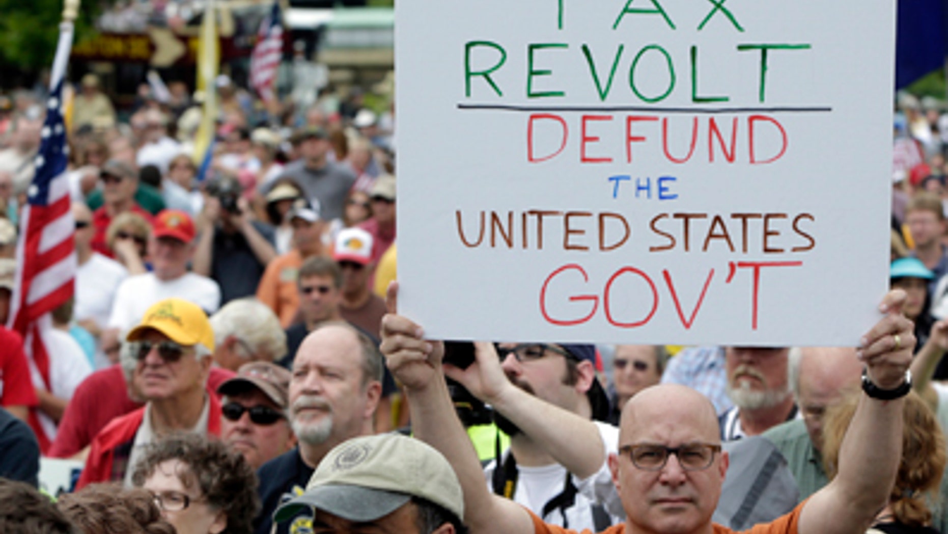June 19, 2013: A man holds up a placard during a Tea Party rally to "Audit the IRS" in front of the U.S. Capitol in Washington.