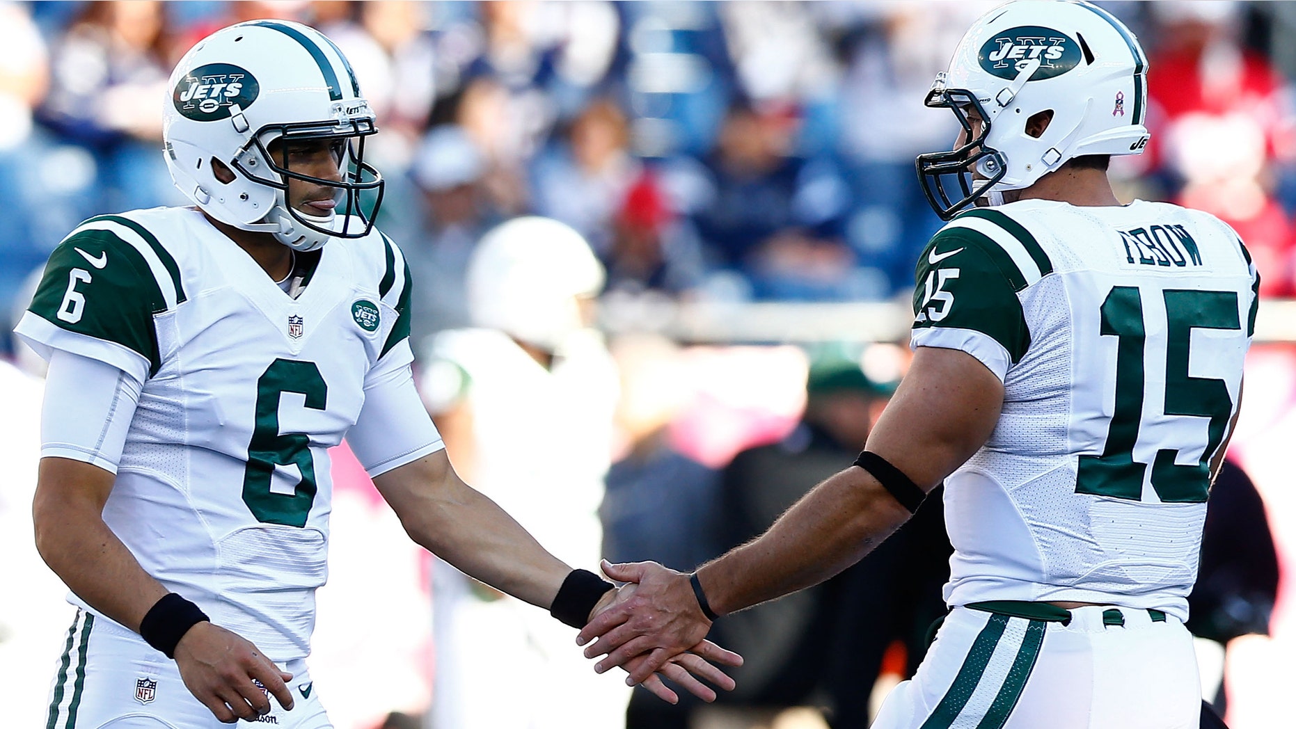 Mark Sanchez #6 and Tim Tebow #15 of the New York Jets high five each other during warm ups prior to the game against the New England Patriots on October 21, 2012. (Photo by Jared Wickerham/Getty Images)