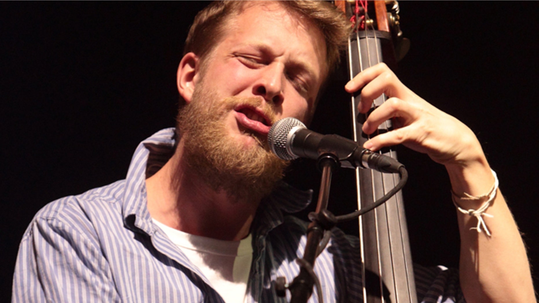 This Feb. 16, 2013 file photo shows Ted Dwane, of the English folk rock band Mumford & Sons, performing at the Susquehanna Bank Center in Camden, N.J. Dwane has a blood clot on his brain that will require surgery.