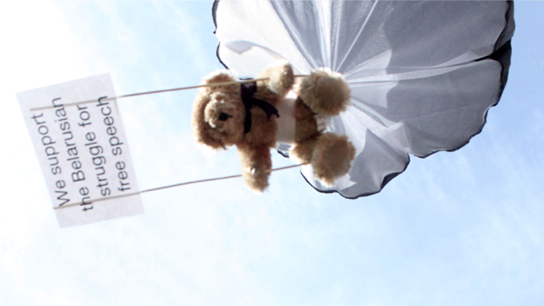 In this undated photo provided by Studio Total teddy bears hang on parachutes during a training in Stockholm, Sweden.