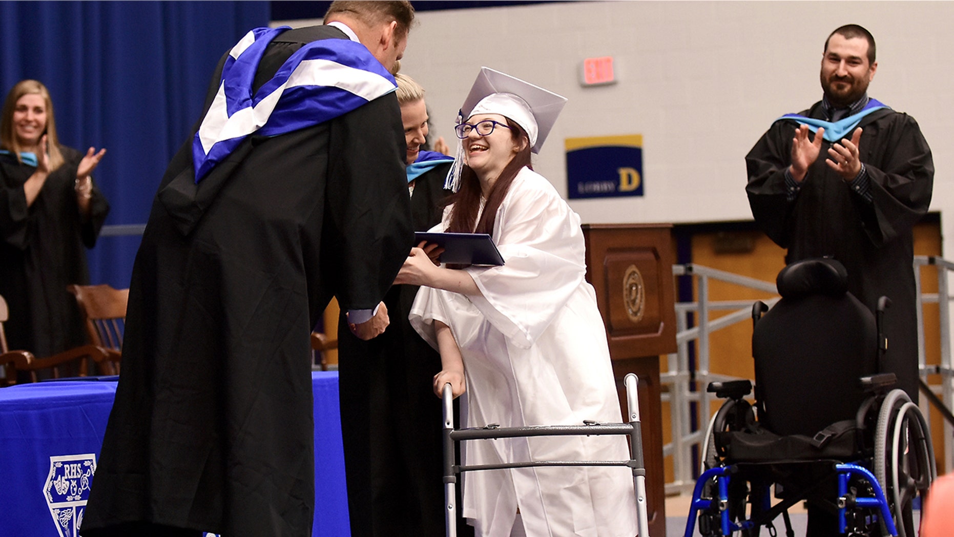 Lexi Wright left her chair and walked across the stage and down the ramp to accept her diploma at Ravenna High School's graduation on Wednesday, May 30, 2018, at Kent State University in Kent, Ohio, to a standing ovation. The Ohio teenager has cerebral palsy and was never expected to be able to walk has shocked her family by doing just that at her high school graduation.