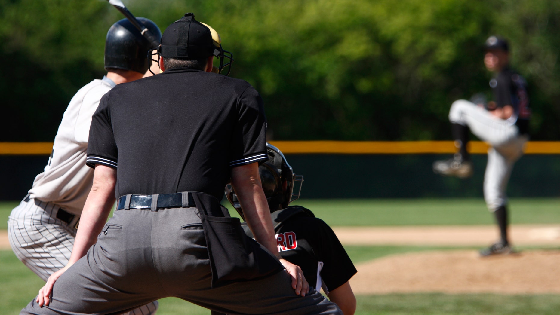 A batter about to hit a pitch during a baseball game.