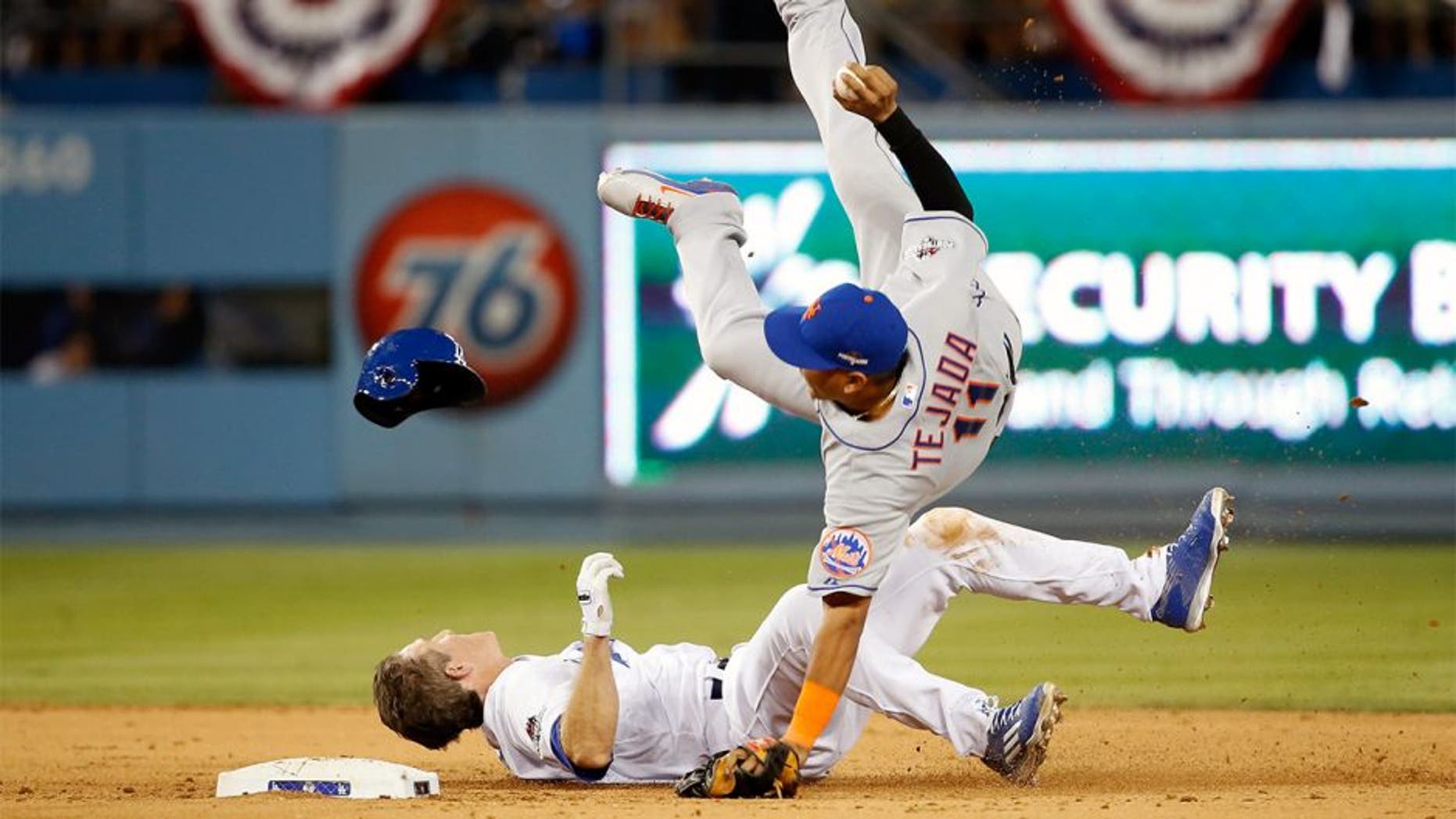 LOS ANGELES, CA - OCTOBER 10: Ruben Tejada #11 of the New York Mets is hit by a slide by Chase Utley #26 of the Los Angeles Dodgers in the seventh inning in an attempt to turn a double play in game two of the National League Division Series at Dodger Stadium on October 10, 2015 in Los Angeles, California. (Photo by Sean M. Haffey/Getty Images)