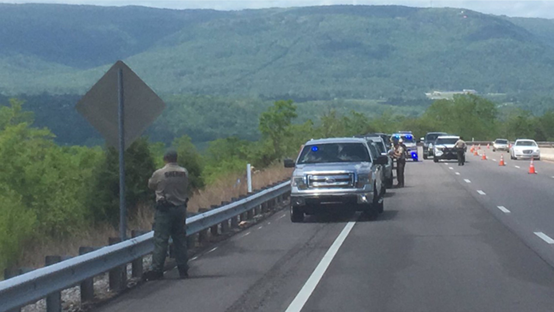 Tennessee sheriff deputies at the spot where a woman jogger's badly decomposed body was found.