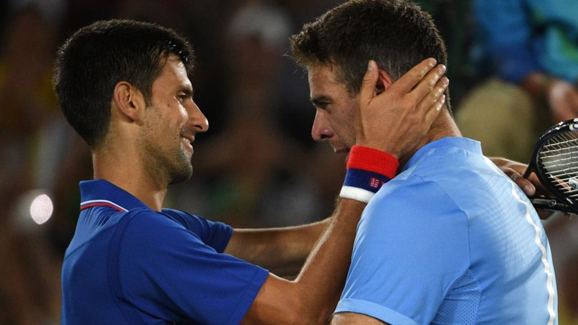 Argentina's Juan Martin del Potro (R) speaks to Serbia's Novak Djokovic after winning their men's first round singles tennis match at the Olympic Tennis Centre of the Rio 2016 Olympic Games in Rio de Janeiro on August 7, 2016. / AFP / Roberto SCHMIDT (Photo credit should read ROBERTO SCHMIDT/AFP/Getty Images)