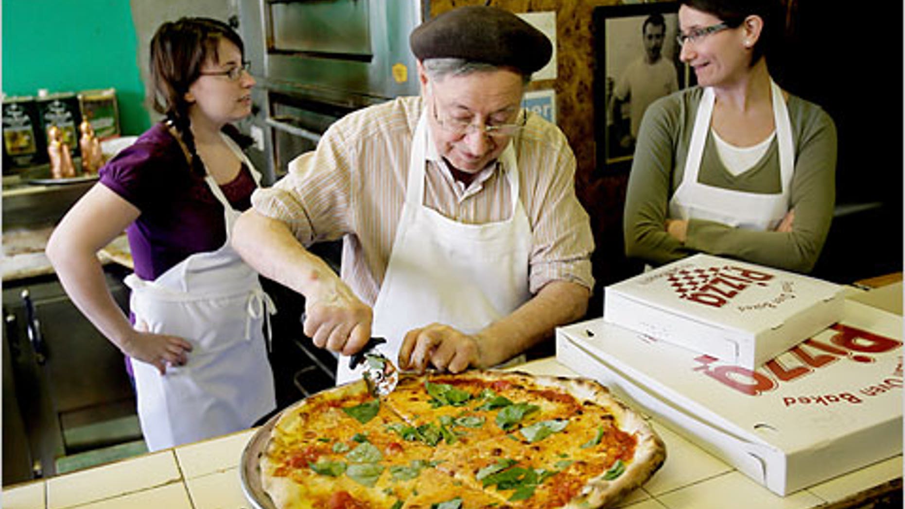 Di Fara pizzeria owner Dominico DeMarco slices one of his legendary pies.