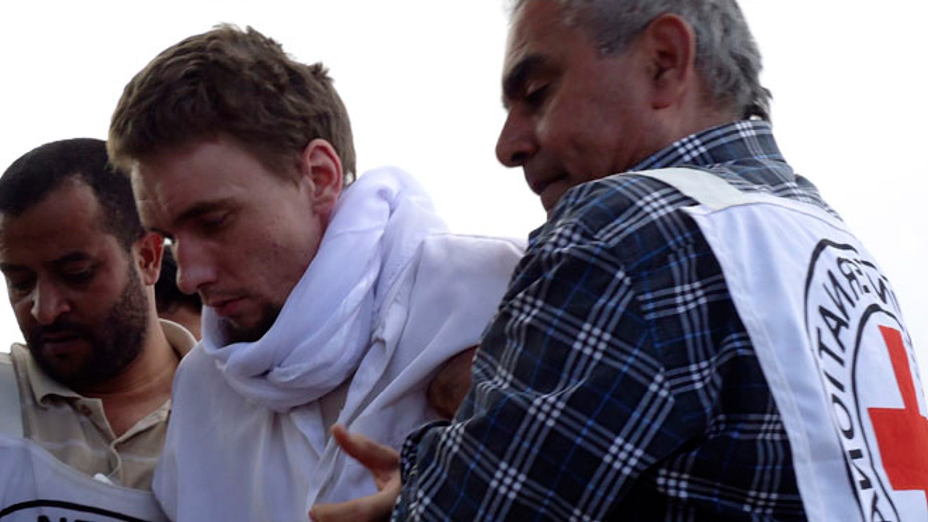 FILE: Nov. 14, 2013: Red Cross medics help a man wounded in fighting at the Saada airport in Yemen, where instability has already helped Al Qaeda militants to take root.