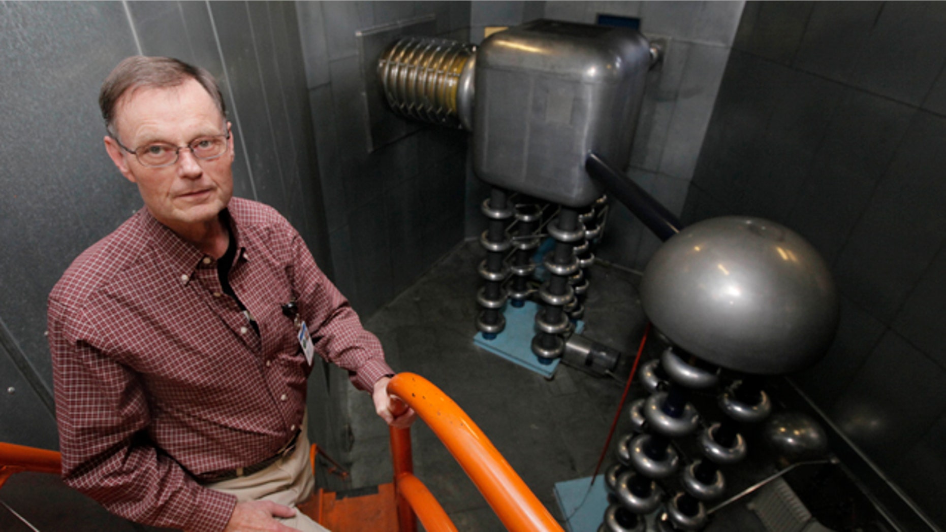 Accelerator Division head Roger Dickson, stands in front of a CockcroftWalton generator at the Fermi National Accelerator Laboratory in Batavia, Ill. a week before its scheduled shutdown.