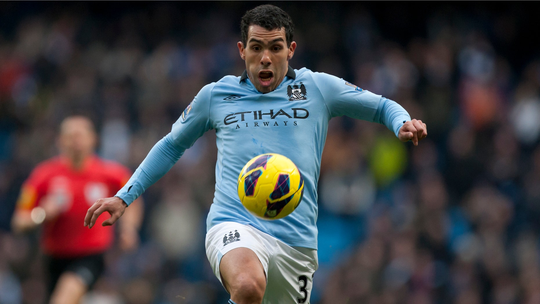 FILE- English Premier League Manchester City soccer player Carlos Tevez in action at The Etihad Stadium in Manchester, England, in this file photo dated Sunday Feb. 24, 2013. Tevez has been arrested in England on suspicion of driving his car while disqualified from driving, police sources confirmed Friday March 8, 2013. Tevez has been released on police bail pending further inquiries.(AP Photo/Jon Super, File)