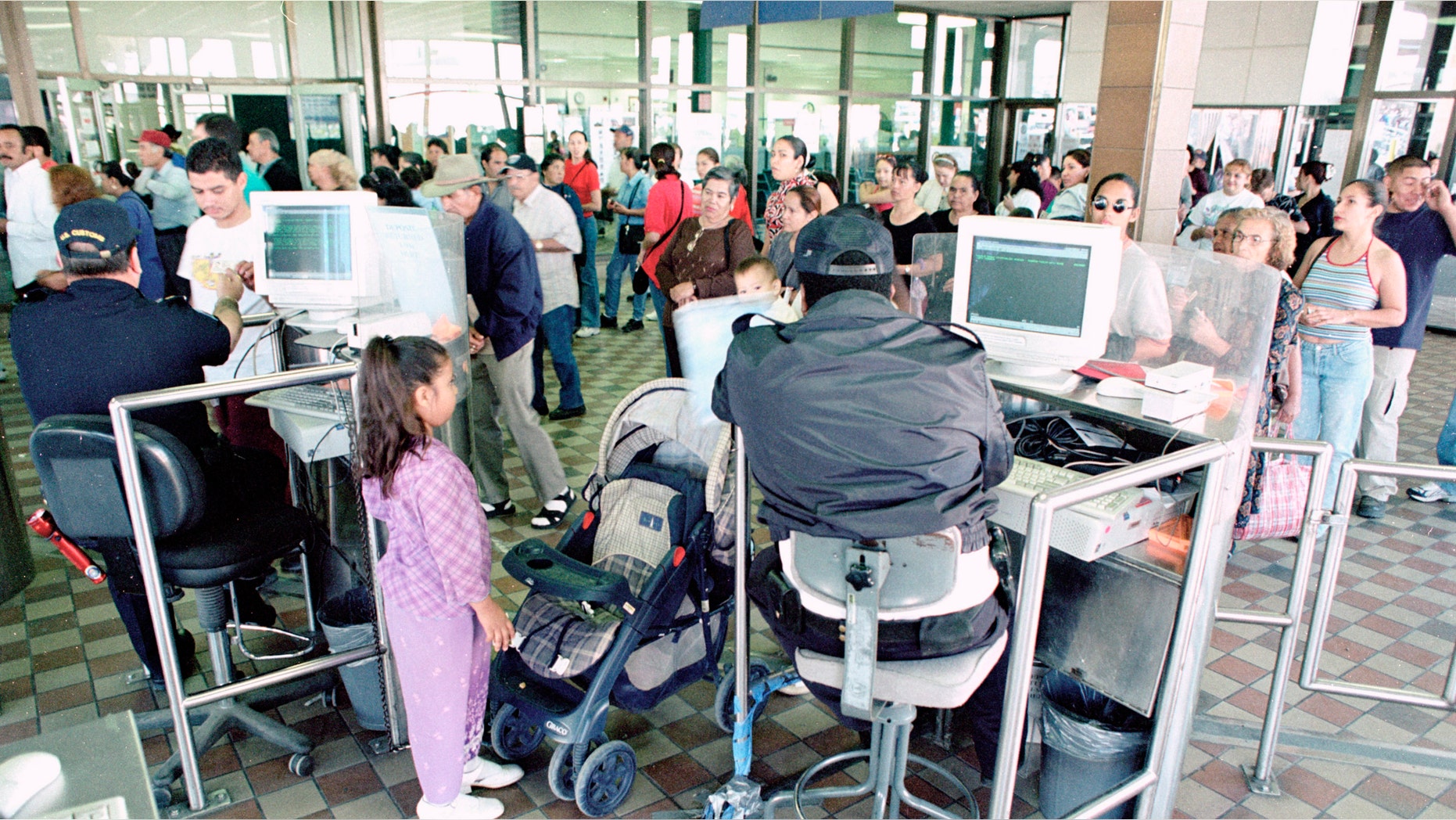 U.S. Customs Inspectors check identity papers at the Paso del Norte port of entry in El Paso, TX.