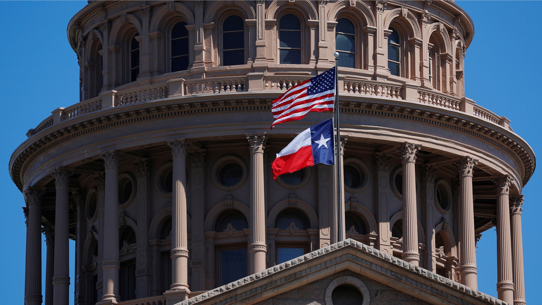 The American flag and the Texas state fly over the Texas State Capitol in Austin, March 14, 2017.