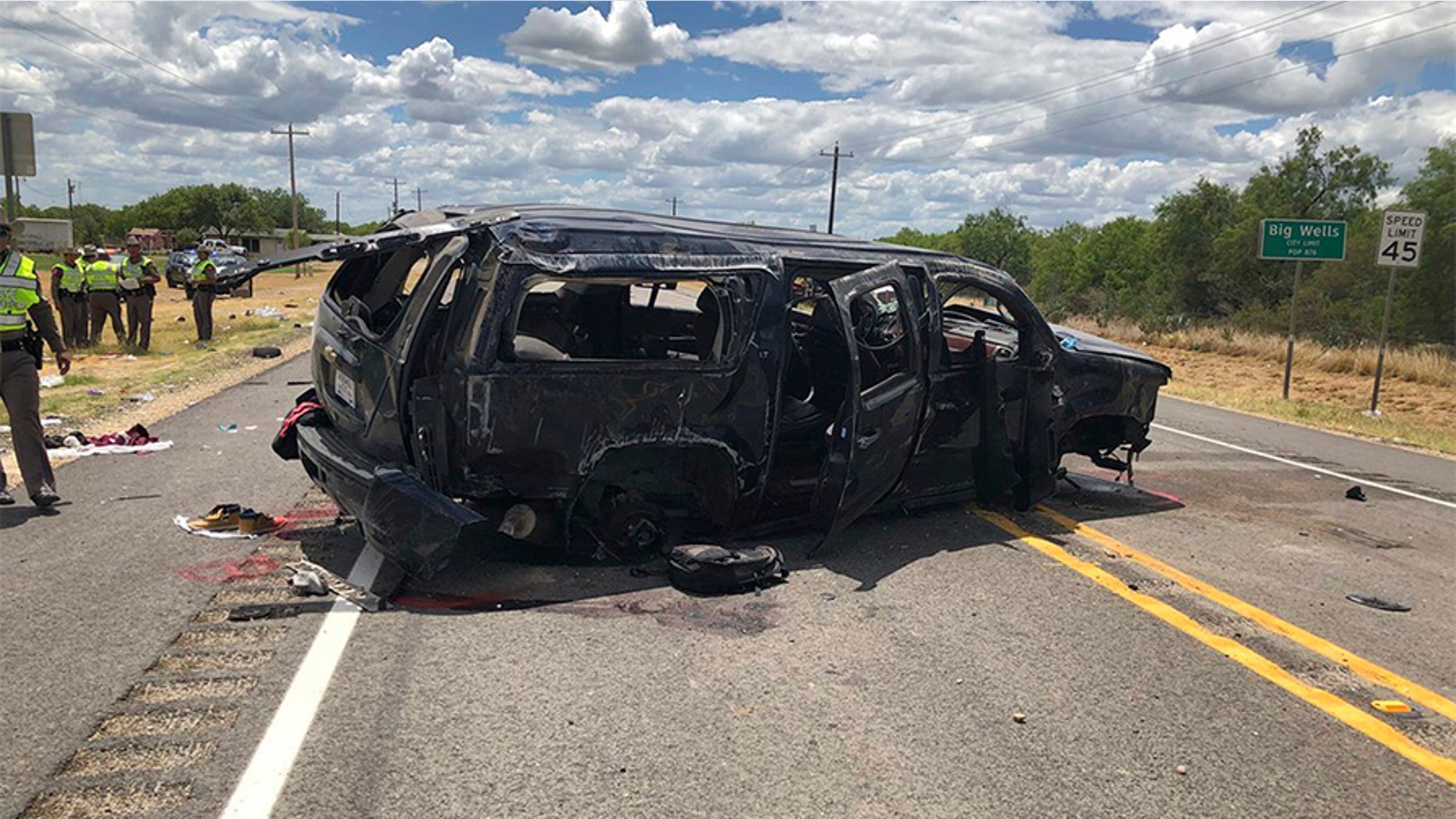 In this image tweeted by David Caltabiano of KABB/WOAI, a heavily damaged SUV is seen on Texas Highway 85 in Big Wells, Texas, after crashing while carrying more than a dozen people fleeing from Border Patrol agents.