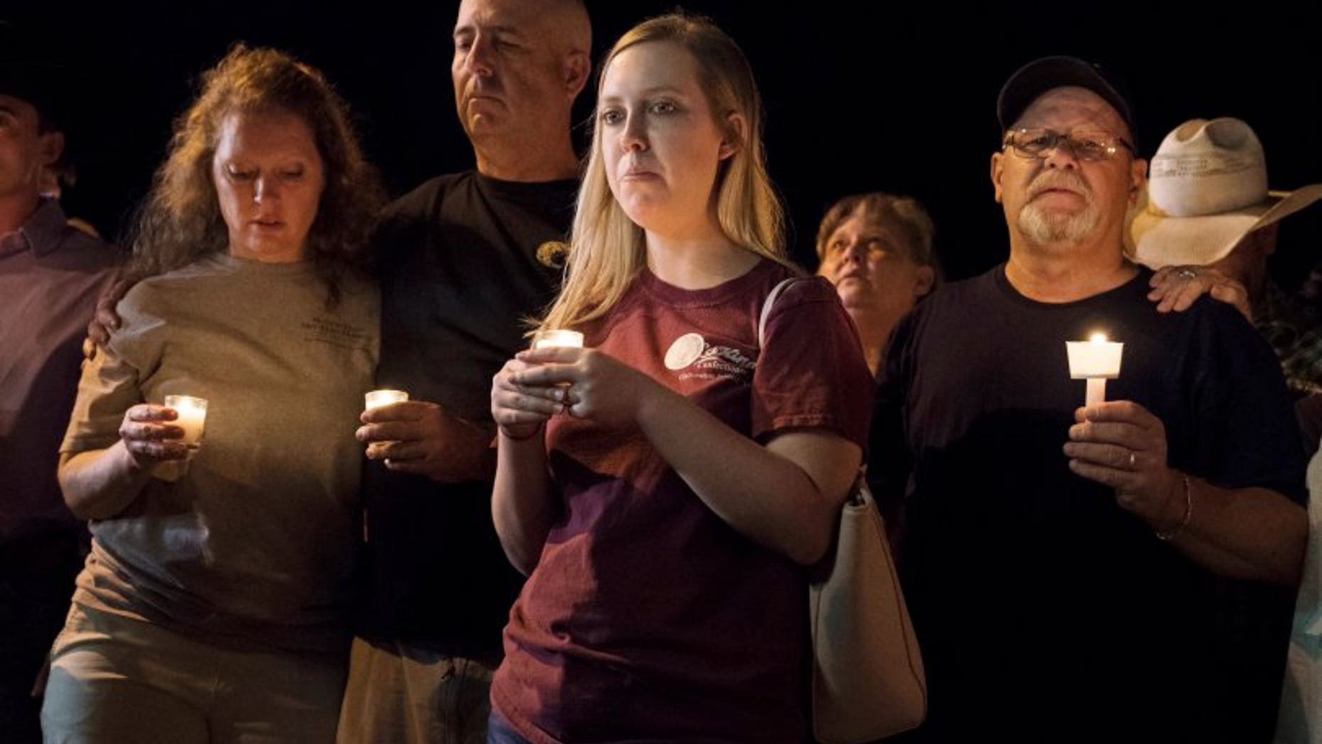 Mourners participate in a candlelight vigil held for the victims of a fatal shooting at the First Baptist Church of Sutherland Springs, Sunday, Nov. 5, 2017, in Sutherland Springs, Texas. (AP Photo/Darren Abate)