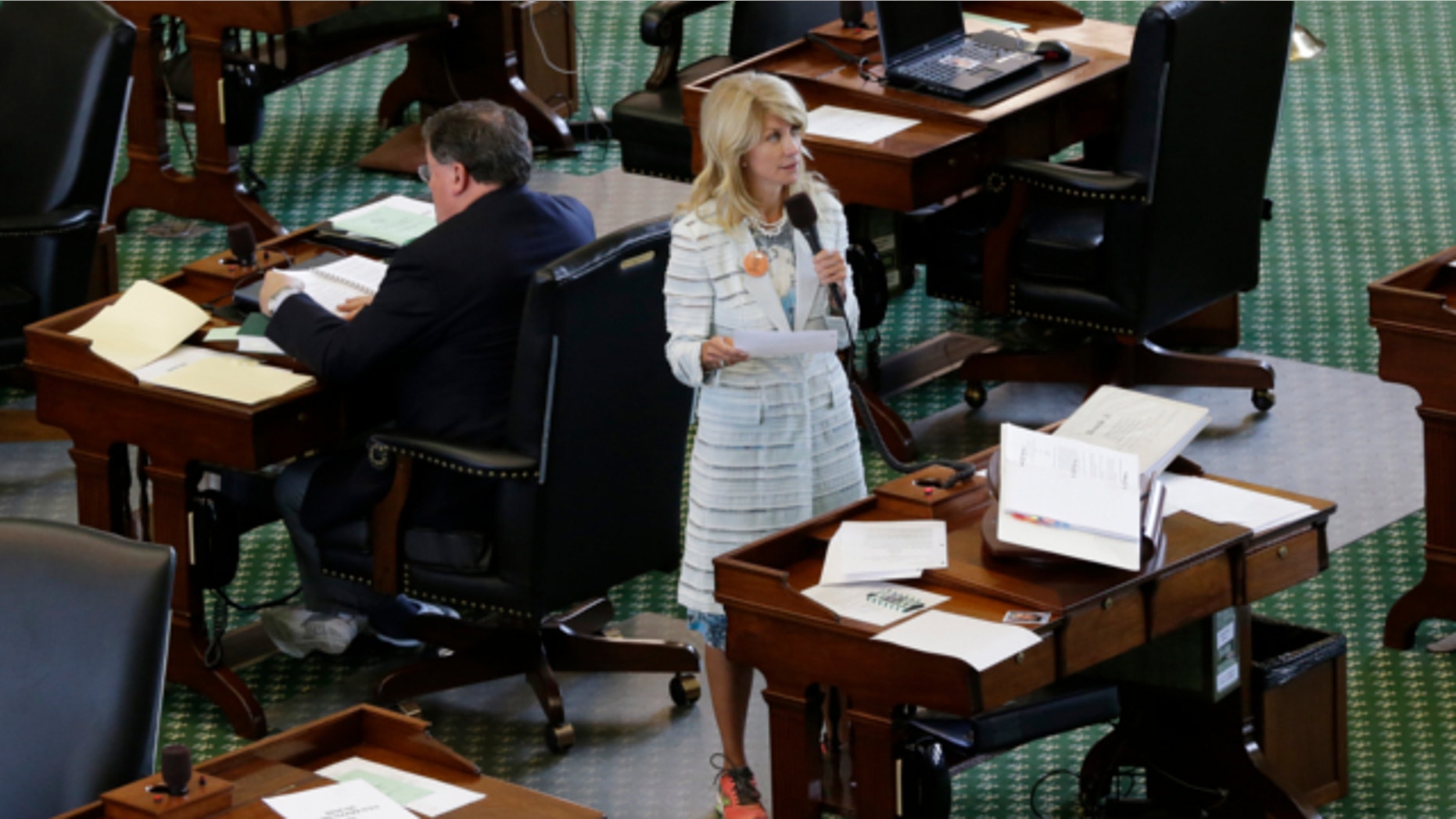 June 25, 2013: Sen. Wendy Davis, D-Fort Worth, stands on a near empty senate floor as she filibusters in an effort to kill an abortion bill in Austin, Texas.