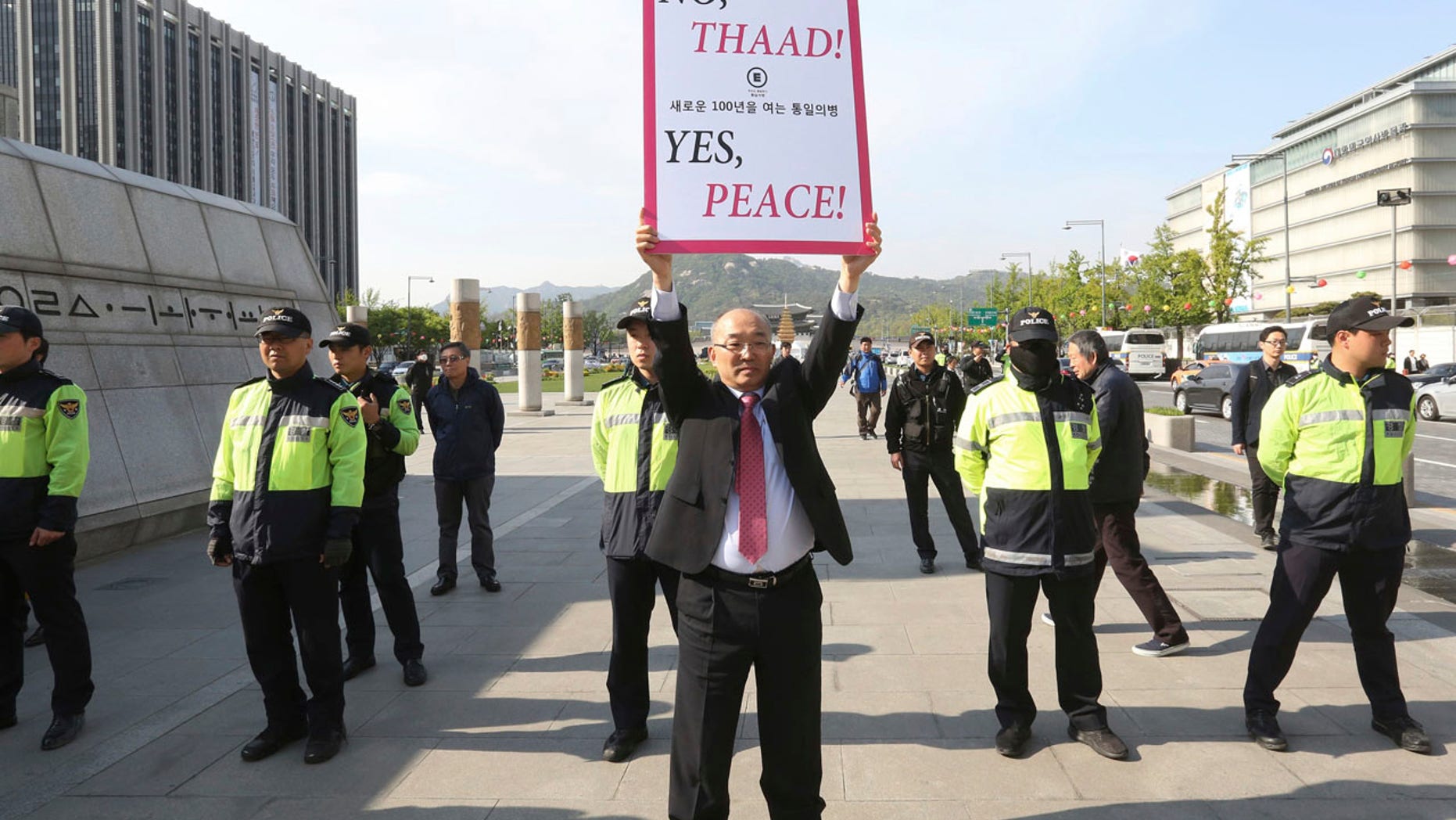 A South Korean protester holds up a placard opposing a plan to deploy the advanced U.S. missile defense system called Terminal High-Altitude Area Defense, or THAAD, near U.S. Embassy in Seoul, South Korea, Thursday, April 27, 2017.