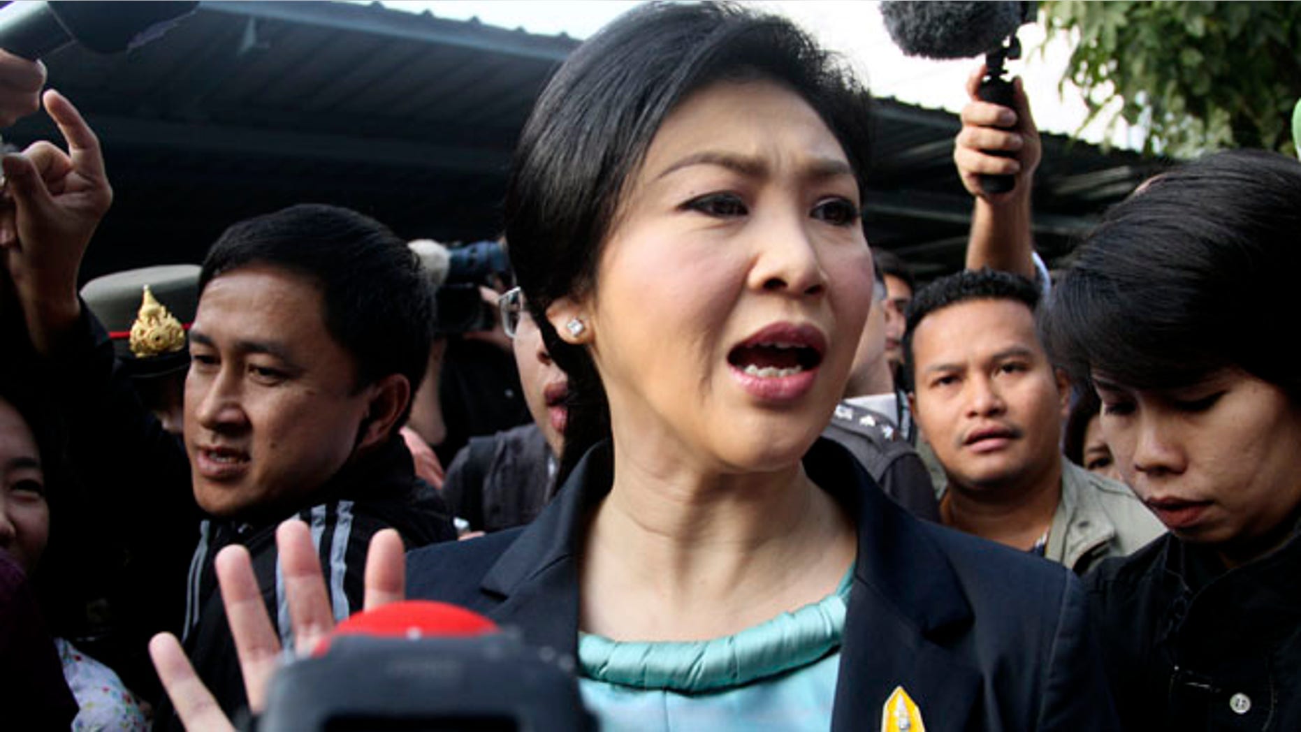 Feb. 2, 2014: Thai Prime Minister Yingluck Shinawatra leaves a polling station after casting her ballot for the general election in Bangkok, Thailand.