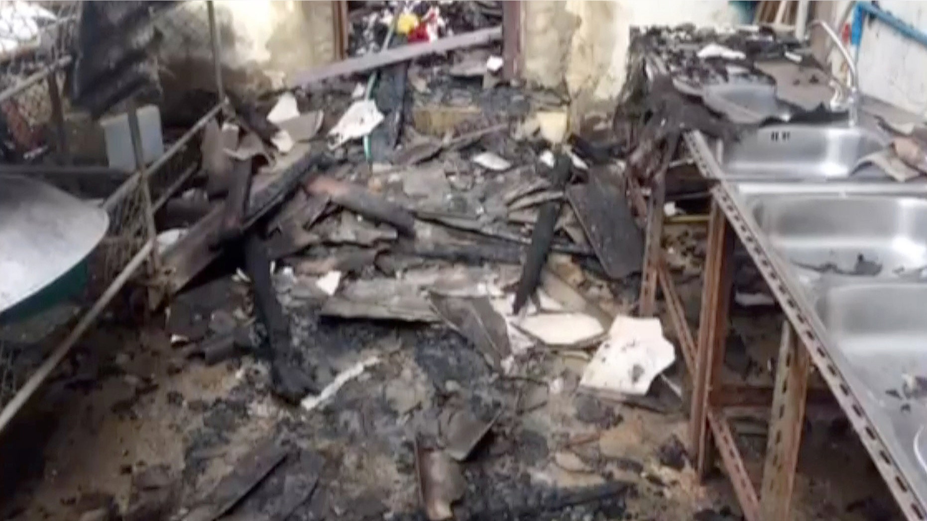 May 23, 2016: This image made from video shows the inside of a damaged school dormitory where local police say 18 girls, ranging from 5 to 12 years old, died in a fire in Chiang Rai province, northern Thailand.