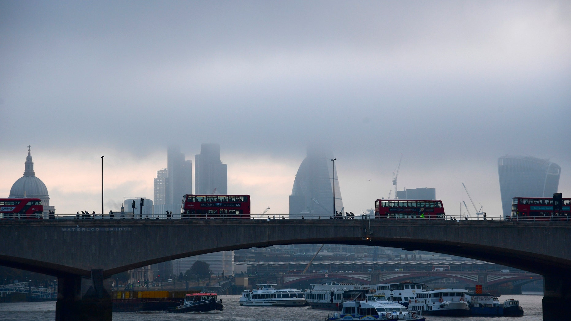 City workers cross the River Thames with the City of London financial district seen behind in London, in Britain October 27, 2016. REUTERS/Toby Melville - RTX2QO8P