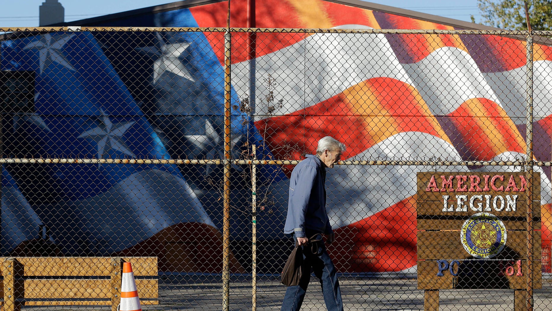 A man walks outside of the American Legion Hall, which served a free Thanksgiving dinner, in Antioch, Calif., Tuesday, Nov. 29, 2016. San Francisco Bay Area health officials were trying to determine if three people who died and five who were sickened after eating the Thanksgiving dinner at the church event held at American Legion Hall got sick there or at the assisted living facility where they all lived. (AP Photo/Jeff Chiu)