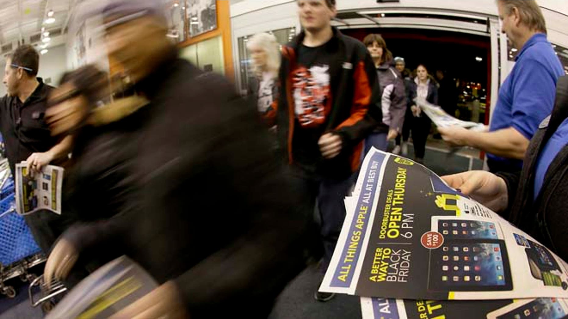 In this Nov. 28, 2013, file photo, shoppers enter a Best Buy as the store opens on Thanksgiving Day, in Overland Park, Kan. Despite the economic tail winds, Americans remain fixated on big discounts and are cherry picking while shopping.