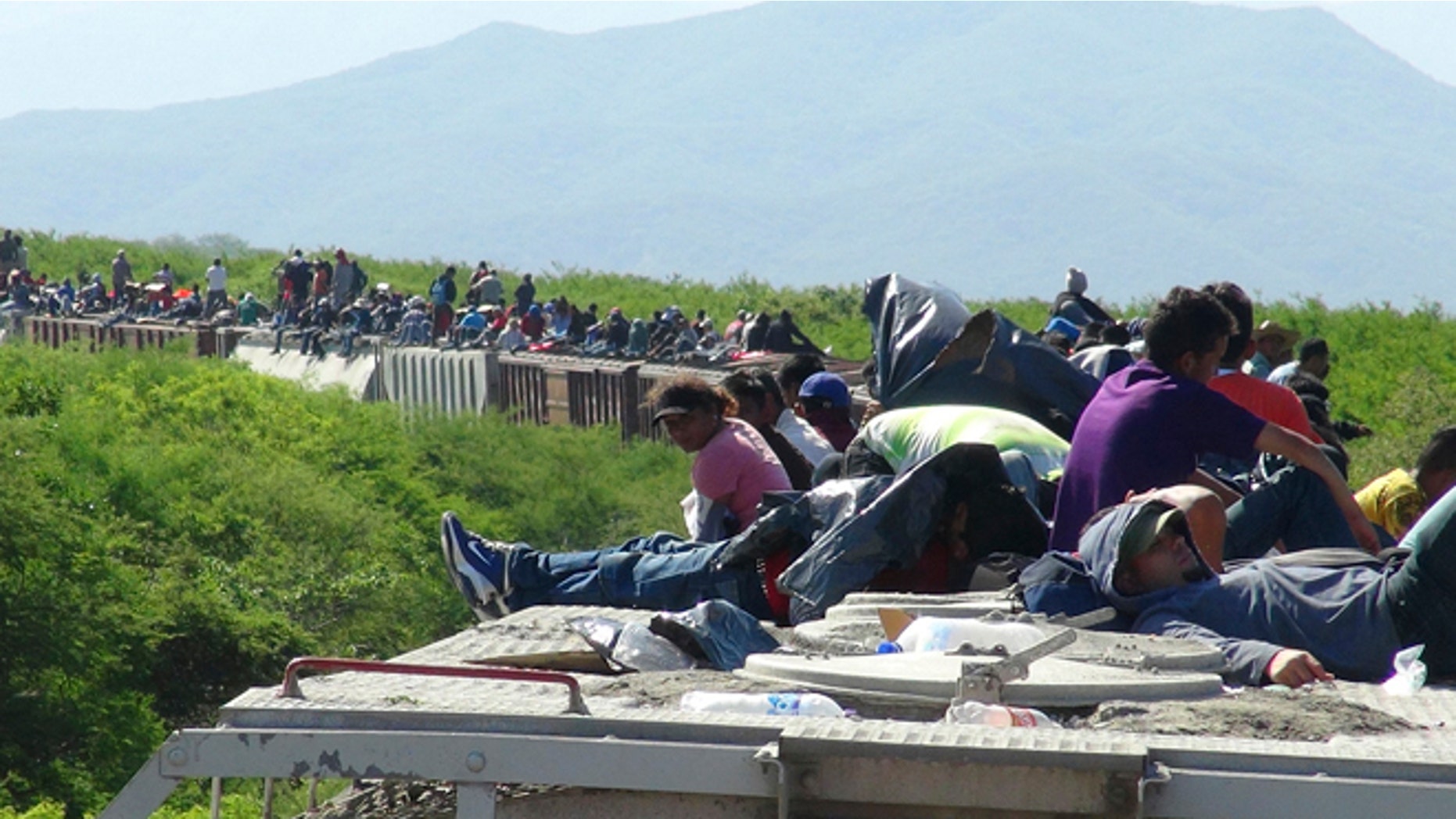June 18, 2014: People hoping to reach the U.S. ride atop the wagon of a freight train, known as La Bestia (The Beast) in Ixtepec, in the Mexican state of Oaxaca. The train derailed on Wednesday, July 9, leaving about 1,300 migrants stranded, authorities said.